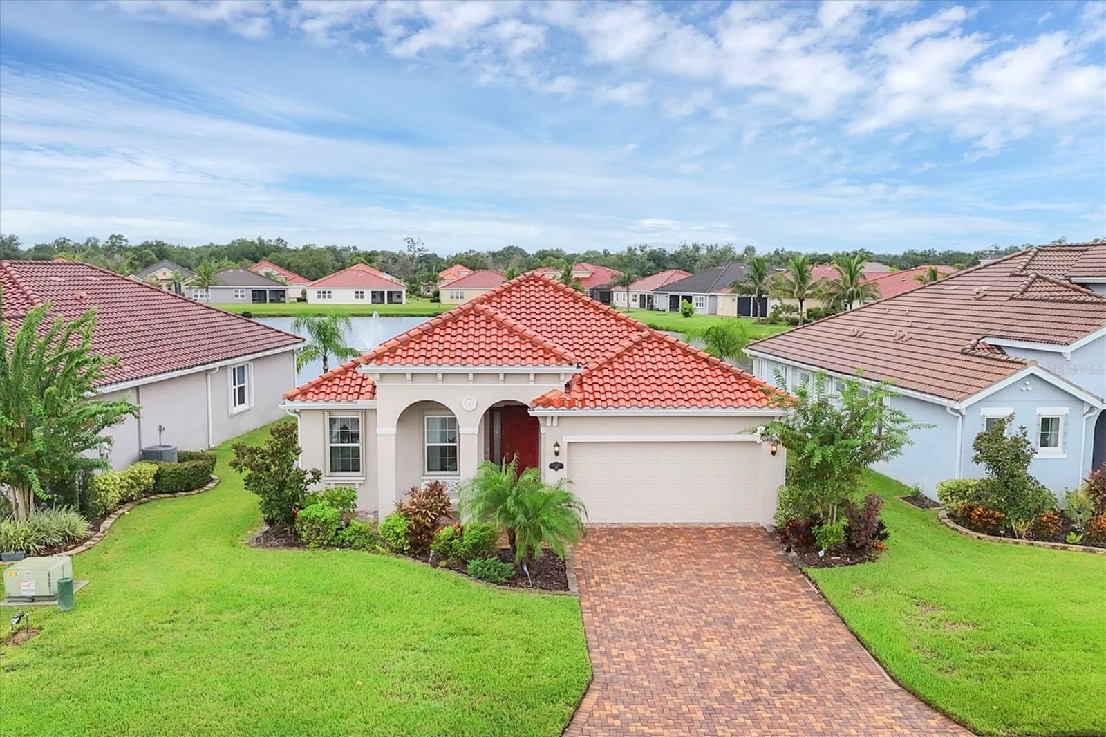 Rare Opportunity in Nalanda Estates – Dream Retirement Haven!
Step into a lifestyle filled with comfort, culture, and community with this immaculately maintained 3 bedroom, 2.5 bathroom home, showcasing the sought-after Munnar I Floor Plan. Perfectly located in the highly desirable Nalanda Estates in Parrish, Florida, this home is not just a place to live—it’s the beginning of a vibrant new chapter.
From the moment you arrive, you’ll notice the thoughtful upgrades and pride of ownership that make this residence stand out. As you step inside, the spacious open layout welcomes you with upgraded tile flooring throughout the main living areas, abundant natural light. The chef-inspired kitchen is a dream, featuring solid wood cabinets, stainless steel appliances, Quartz countertops, an upgraded backsplash, and a custom hood venting outside—perfect for creating meals while entertaining family and friends. This home is thoughtfully designed with numerous upgrades that bring both function and style. The kitchen, bedrooms, mudroom, and garage are all equipped with upgraded cabinetry, providing an abundance of storage and a refined, custom look throughout. The master suite is a true retreat, featuring a beautifully extended walk-in closet for added space and organization, along with a dedicated study area that has been thoughtfully upgraded to create a quiet, productive corner within your private oasis.
One of the secondary bedroom comes with a built-in Murphy bed, making it a versatile space that can effortlessly transition between a guest bedroom and a home office. For added comfort outdoors, the owner has installed a remote-controlled awning, allowing you to enjoy shade and relaxation at the touch of a button. The extended lanai overlooking a peaceful lake view offers the perfect setting to enjoy your morning coffee/tea or evening coffee/tea, soak in the serenity, or host gatherings in the beautiful Florida weather.
This home was built with • Hurricane accordion shutters for peace of mind • Gutters installed for added functionality. If gardening is your passion, you’ll love the opportunity to create your very own backyard retreat, whether that’s fresh vegetables, fruit trees, or a flourishing herb garden—already made simple by the home’s layout and yard space.
Beyond the home itself, Nalanda Estates offers a lifestyle like no other. This is not just a community—it’s a Dream Retirement Haven where neighbors become lifelong friends. Enjoy a huge ballroom for cultural celebrations and social events, a theater room showing Bollywood movies, a resort-style pool, pickleball courts, fitness center, and dedicated areas for cards, bingo, and group activities. With a full calendar of events and daily opportunities to connect, there is always something to do, something to celebrate, and someone to share it with.