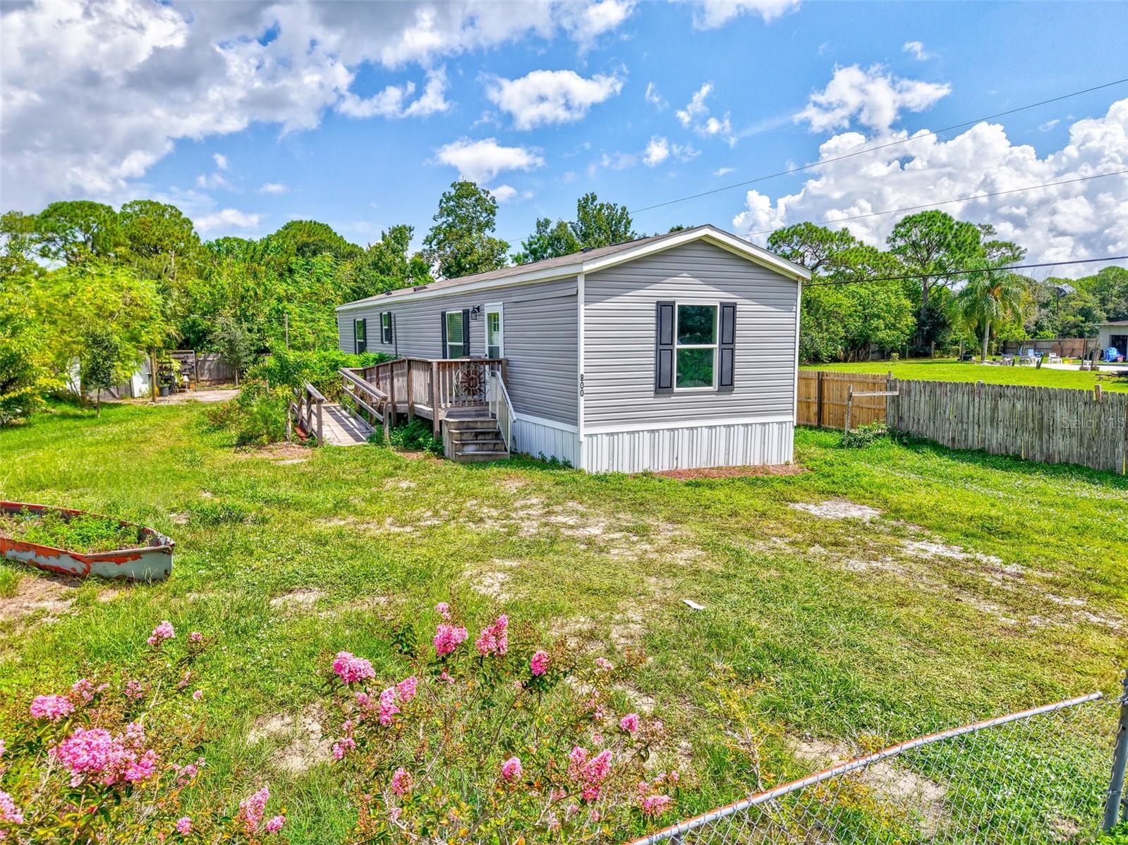 Under contract-accepting backup offers. Welcome to your new home in Canaveral Groves. This beautifully designed 2023 manufactured home sits on a spacious ¼ acre lot featuring a fenced yard with a wide entrance gate and a charming garden. Inside, you'll love the luxury vinyl flooring throughout, a modern kitchen with a large island, and two generously sized bathrooms with stylish finishes.
Enjoy peace and comfort on a quiet street with no rental restrictions. You own both the land and the home.