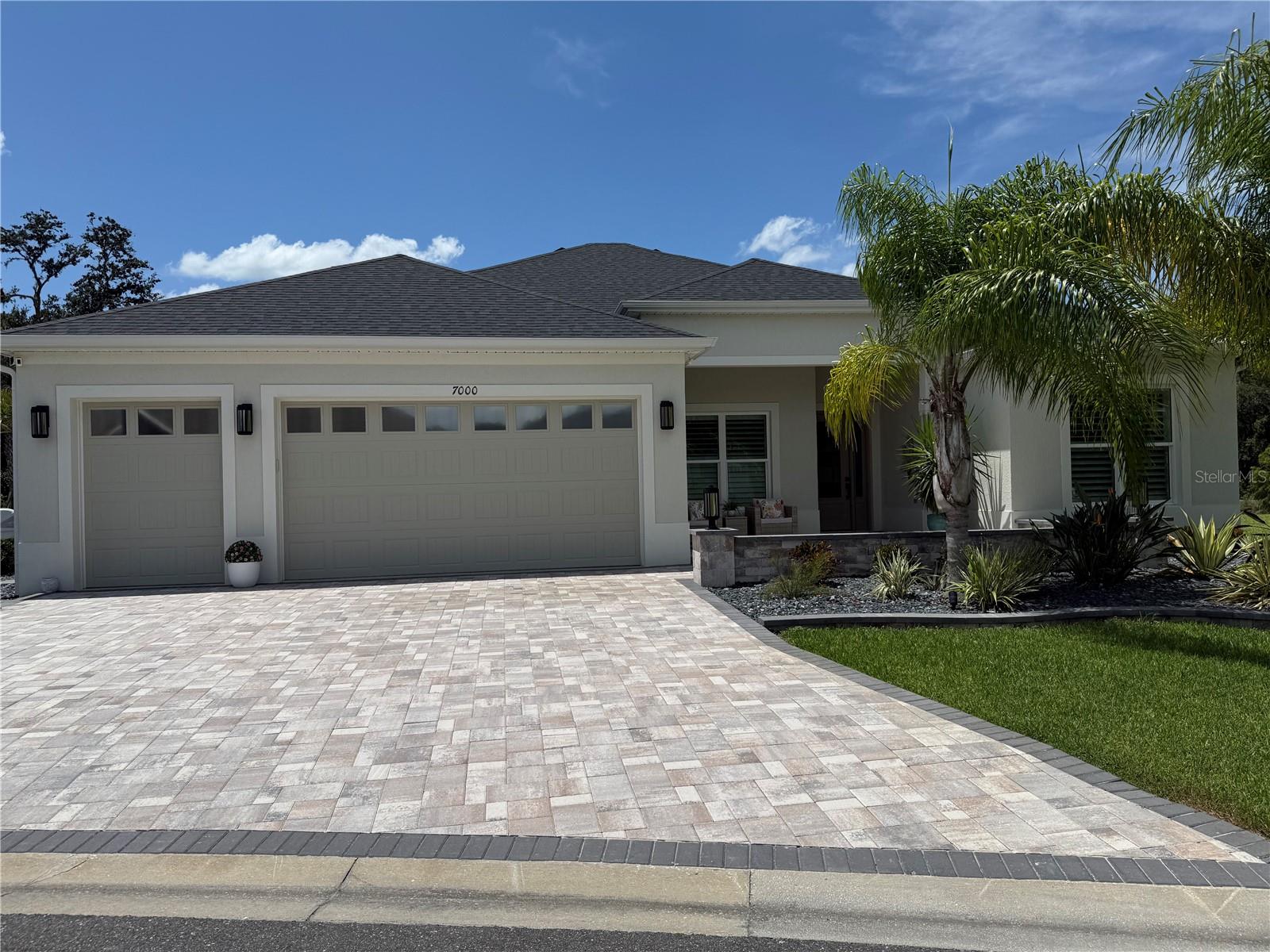 Experience elevated living in this exceptional 4-bedroom, 3-bath Sanderling Premier Series home located in the highly desirable Village of Lake Denham in The Villages, Florida. Just minutes from the exciting new Eastport and Sawgrass Square areas, this home sits on a premium oversized lot with no rear neighbors—offering privacy, peaceful views, and beautiful landscaping on a quiet street.
Inside, the home features 10-foot ceilings, 8-foot doors, Mohawk luxury vinyl plank flooring, and tile in all bathrooms. The gourmet kitchen includes quartz countertops, upgraded cabinetry, a tile backsplash, under and above cabinet lighting, and Café Wi-Fi appliances, including a smart refrigerator with on-demand hot water and a gas stove. The open-concept layout flows into the main living area, where pocket sliding glass doors connect the indoors to the expanded screened lanai for seamless indoor-outdoor living. The primary suite features a spa-style bathroom with a walk-in, no-glass shower and dual custom closets. The fourth bedroom is designed with a built-in desk, perfect for a home office or hobby space. Additional interior upgrades include plantation shutters, 6-inch baseboards, upgraded lighting and fans, smart LG washer and dryer, Wi-Fi-enabled light switches and garage door opener, a tankless water heater, and a UV light in the HVAC system for hospital-grade air quality.
The oversized garage offers parking for two vehicles plus additional space for multiple golf carts, 50 amp plugin for EV charging ,includes a hanging ceiling storage shelf for added organization. The garage is extended, features an extra-tall door with windows for natural light, and has attic stairs for convenient overhead access. Outside, the home is professionally landscaped with pavers, slate rock, accent lighting, and mature palm trees. Both front and rear courtyards feature pavered walkways and decorative knee walls. The expanded lanai is perfect for entertaining, with a custom-built Paradise Grill outdoor kitchen featuring a refrigerator and storage. A gas-heated spa with a waterfall and color-changing LED lighting creates a relaxing backyard retreat, and the oversized lot also offers plenty of room to add a future pool.
With close proximity to golf, recreation, shopping, and entertainment, this home blends luxury, smart design, and comfort in one of Florida’s most desirable 55+ communities. Shown by appointment only. Owner is Agent.