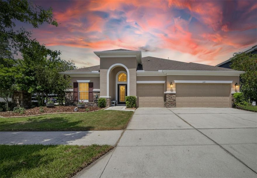 Welcome to your dream family home in the highly sought-after Channing Park community, where you'll enjoy the best of Florida living! This stunning Taylor Morrison home boasts 4 bedrooms, 3 baths and a 3-car garage. Step inside and be greeted by a spectacular three way split floor plan. Master suite on the one side of the house, offers ultimate privacy and comfort. You'll love the the walk-in closet with customized extra storage space. Two other bedrooms sharing the large family bathroom with double sink on the opposite side of the house and guest bedroom (or could be an office) with additional bathroom by the entrance. All bathrooms have wood cabinets and granite countertops. The luxurious kitchen features upgraded granite countertops, stainless steel appliances, and a gas range, making it a chef's delight. There is no carpet in the house! You will love tastefully updated high quality engineered hardwood flooring in all bedrooms. House offers spacious laundry room complete with a sink and bespoke features. Unwind and relax on the extended fully screened and covered lanai, accessed through sliding glass doors. This is the perfect space for outdoor entertaining or simply enjoying the Florida sunshine. The fully fenced spacious backyard, ideal for your furry family members. As a resident of Channing Park, you'll have access to incredible amenities including TWO resort-style pools, splash pad, hot tub, playground, clubhouse, gym, skatepark, dog park, soccer field, and basketball court. Top-rated schools provide an excellent education. Don't miss out on this opportunity to own a truly exceptional home in Channing Park. Schedule your private showing today and start living the Florida lifestyle you've always dreamed of!