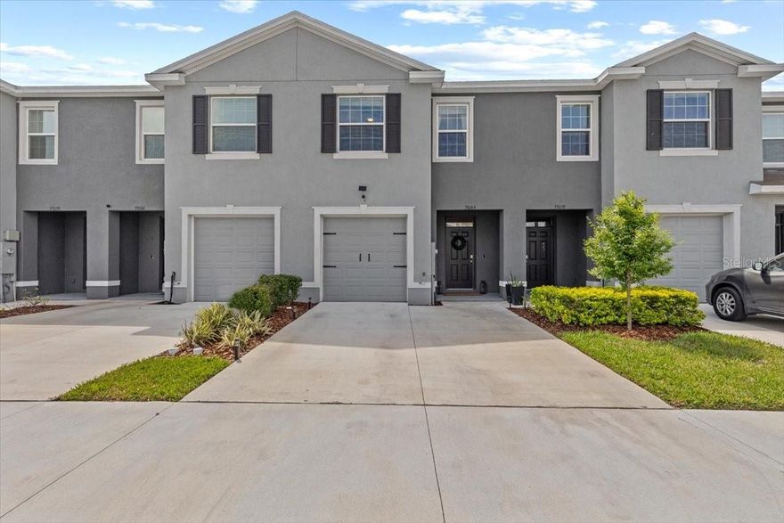 Why wait, pay more, & live thru construction? This 2023-built, meticulously upgraded townhome in Avalon Park West delivers new-construction look buyers want w upgrades, warranties, & certainty builders can’t give. From the moment you arrive, this home stands apart w a rare 2-car driveway, added garage storage, & professionally finished epoxy garage floor, warranty inc, all features builders often charge thousands for. Inside, the open-concept layout is bright, modern, & thoughtfully enhanced. The main level offers durable tile flooring, an upgraded kitchen w granite countertops, stainless appliances, pantry, & island seating, & triple sliding glass doors that open to a screened lanai, perfect for morning coffee or evening unwinding without bugs or maintenance headaches. Upstairs, all bedrooms feature ceiling fans, the home shines with two fully renovated bathrooms, custom stair wall detailing, & smart, functional design throughout. The HVAC system is like new & under warranty, offering peace of mind. HOA covers water & landscaping. Fees are scheduled to be reduced in 2026, a rare win for future affordability. Residents enjoy access to 3 amenity centers, an intuitive HOA portal, & community designed for long-term living, not temporary sales hype. Avalon Park West offers resort-style community buyers actively seek like new pickleball courts, multiple pools, splash pads, playgrounds, dog parks, neighborhood parks, grilling stations, walking trails, weekly food trucks, movies, festivals, activity groups, all w top-rated neighborhood schools. Even better, Avalon Park Downtown is now open, w a dedicated access road underway exclusively for residents, adding restaurants, retail, & community energy just minutes from your door. Located along SR-54, residents enjoy easy access to I-75, Tampa, Lakeland, Wiregrass, Tampa Premium Outlets, major hospitals, & employment hubs, all while coming home to a true neighborhood feel rather than a construction zone. New builds nearby may advertise a lower base price, but they don’t include completed upgrades, reduced HOA fees on the horizon, transferable warranties, immediate move-in readiness, & a finished & active community. This home does. No waiting, no guessing, no compromises.