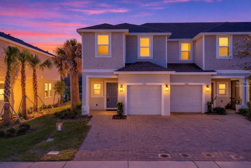 One or more photo(s) has been virtually staged.

Now available for rent, this beautifully maintained 3-bedroom, 2.5-bath luxury townhome at 2596 Penguin Blvd offers the perfect blend of privacy, convenience, and low-maintenance living. Tucked into a quiet corner with serene conservation views, this desirable end unit is filled with natural light from multiple sides, creating a bright and welcoming atmosphere throughout its 1,574 square feet of thoughtfully designed space.

Step inside to an open and airy layout ideal for both everyday living and entertaining. The spacious living and dining areas flow seamlessly into the modern kitchen, featuring sleek cabinetry, ample counter space, and a practical layout that makes meal prep effortless. Whether hosting guests or enjoying a quiet night at home, the main living space is both comfortable and functional.

Upstairs, you’ll find three well-appointed bedrooms, including a generous primary suite that serves as a peaceful retreat. The ensuite bathroom offers privacy and comfort, while the additional bedrooms provide flexibility for family, guests, or a home office. A convenient half bath downstairs is perfect for visitors, and the upstairs laundry along with a full second bath ensures ease in your daily routine.

One of the standout features of this home is its tranquil conservation backdrop. Instead of facing another building, you’ll enjoy peaceful green views that provide a rare sense of privacy. Morning coffee or evening relaxation becomes even more enjoyable with nature as your backdrop.

Designed for low-maintenance living, exterior upkeep is handled for you—no mowing or exterior maintenance required. The single-car garage offers additional storage and protection for your vehicle, while the driveway and nearby guest parking provide everyday convenience.

Located less than 20 minutes from Walt Disney World, this home puts you in the heart of Central Florida with easy access to world-class attractions, shopping, dining, and entertainment. The community is clean, well-maintained, and features sidewalk-lined streets and manicured landscaping, creating a welcoming environment you’ll love coming home to.

With its combination of privacy, modern comfort, and unbeatable location, this townhome is an exceptional rental opportunity. If you’re looking for a low-maintenance lifestyle in one of Central Florida’s most convenient areas, 2596 Penguin Blvd checks every box.