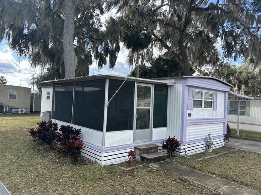 Access to Lake Yale!! Don't miss this 2 bedroom home in Sandpier Mobile Home Park a great 55+ Community in Leesburg! Living room has laminate flooring, kitchen with glass cooktop and eat in area. Primary bedroom has built in closet, bathroom has tub/shower, 12x9 screen porch, 38x12 two car carport with an attached 10x9 laundry/workshop area. This community boasts a recreation clubhouse and new pool. Plus access to beautiful Lake Yale, with boat ramp, boat docks, dock on lake, sandy beach area, shuffleboard, picnic area and golf cart friendly. This home includes co-op share. You'll defenitly want to see this one.