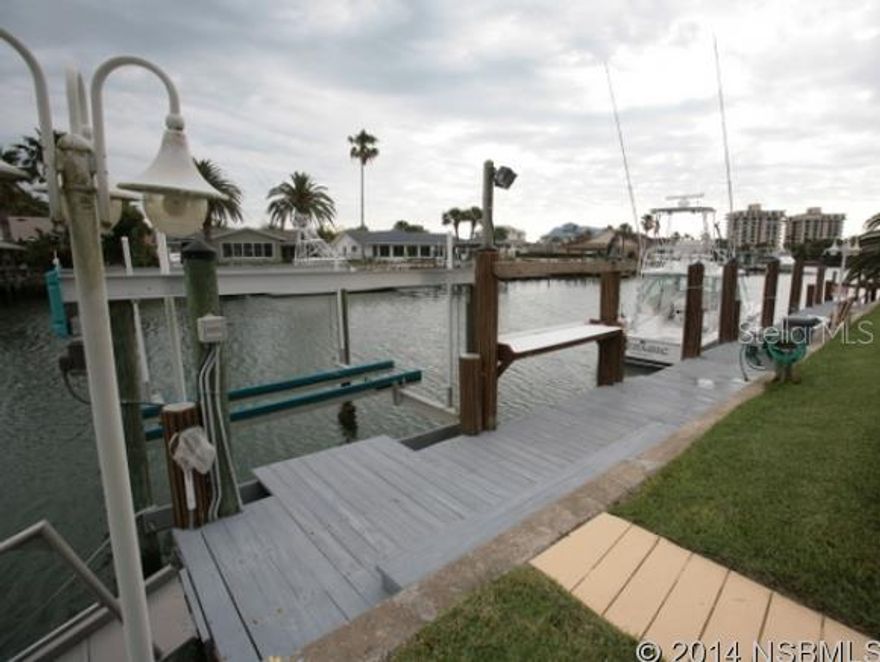 Waterfront pool home on direct intracoastal access in Prime New Smyrna Beach North Beach. A  must see in the beautiful upscale Venezia community. Special features include a boat house, floating dock, 120' if seawall, deep wide canal with extra moorings, private 30x15 pool and mature landscaping. Separate fishing tack room; 12,000 lb lift;  2011 Lenox A/C; Alarm system; Floating dock; Chain link fence; Corian countertops and mature landscaping.  This home is move in ready! Call Today! ;Water: City