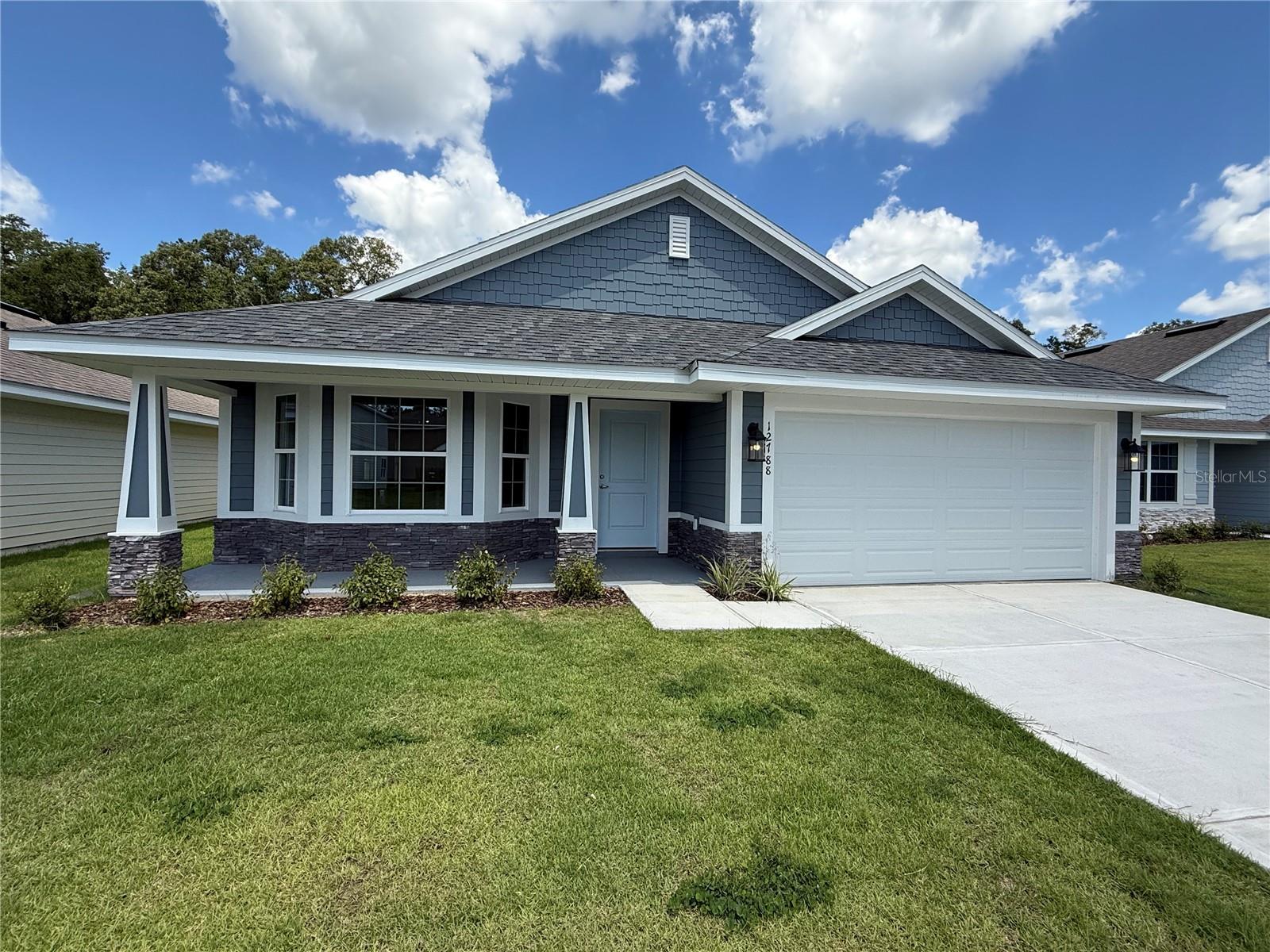 Seller concessions include a special finance rate of 4.99%. The rate applies to builders' preferred lender, FBC Mortgage, which utilizes FHA, VA, USDA, conventional loans, or up to $20,000 towards closing costs. SAVANNAH STATION A, FL, is in a quiet, country-like area close to all your shopping needs. Three-bedroom, two-bath 1780 SQFT. LOT 256 with Hardy Siding, stacked stone accents on the exterior, and a LARGE COVERED FRONT PORCH. Great location close to Gainesville, Florida, LAKE CITY, Alachua, features LVP in the wet areas and throughout the main home, excluding bedrooms. The formal dining room and large family room lead to the backyard, with a covered Lanai and a new wood FENCE. The spacious Primary Suite features a double-door closet, a granite double-sink vanity, a walk-in shower, and a Garden Tub. The kitchen area features an extensive Island that overlooks the Family room. This prominent kitchen features upgraded cabinets, Granite Countertops, a Stainless Steel Frigidaire appliance, a Range, a Dishwasher, a microwave, and a disposal. Brushed Nickel Faucets, LED lighting throughout. The kitchen is attached to the walk-in laundry room and the 2-car Garage, featuring a Built-in Pest Defense System. Energy-Efficient HVAC System: Please note that pictures of this home may differ from the actual home. *Colors and features have been chosen for this home. Taxes are based solely on land taxes. Prices are subject to change without notice.