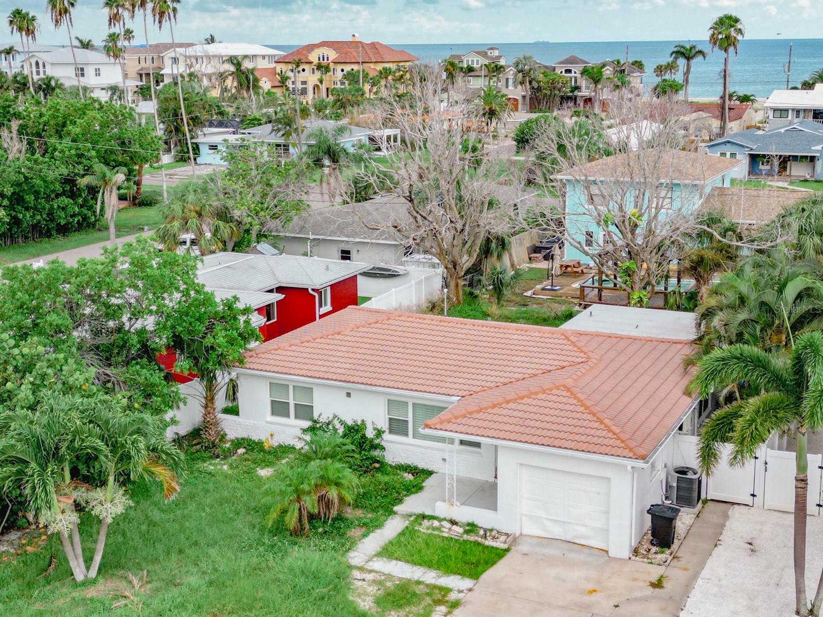 Whether you’re ready to bring this beauty back to life or build your dream beach home, this is your opportunity to enjoy the island lifestyle in one of the most desirable beach communities on the Gulf Coast. This 3-bedroom, 2-bath beach home in the charming residential neighborhood of Redington Beach is just 5 homes from the sand. This one-of-a-kind property offers exceptional value and location. Make it your primary residence, second home beach getaway, or enjoy the income potential of a short-term rental—so close to the beach it is sure to perform well. This home had never flooded before but was affected by Hurricane Helene shortly after receiving a number of high-end upgrades. Features include hurricane-rated windows throughout, plantation shutters, modern light fixtures, smart electrical outlets, new upper kitchen cabinets, waterfall quartz countertops, a copper farm sink, and a stunning main bathroom in need of only a new vanity, mirror, and drywall to be complete. The home offers a spacious living room, dining area, and a full dining space off the kitchen. The split-bedroom layout ensures comfort and privacy for hosting guests. The backyard is ideal for entertaining with room for a pool, a row of mature areca palms offering privacy, and plenty of space to relax outdoors. Additional features include a one-car garage with laundry area, a red tile roof, and an extended driveway for added parking. Don’t miss out on this beachside gem just right around the corner from the Gulf! Schedule your private showing today or explore the home from anywhere with the included virtual Matterport 3D tour.