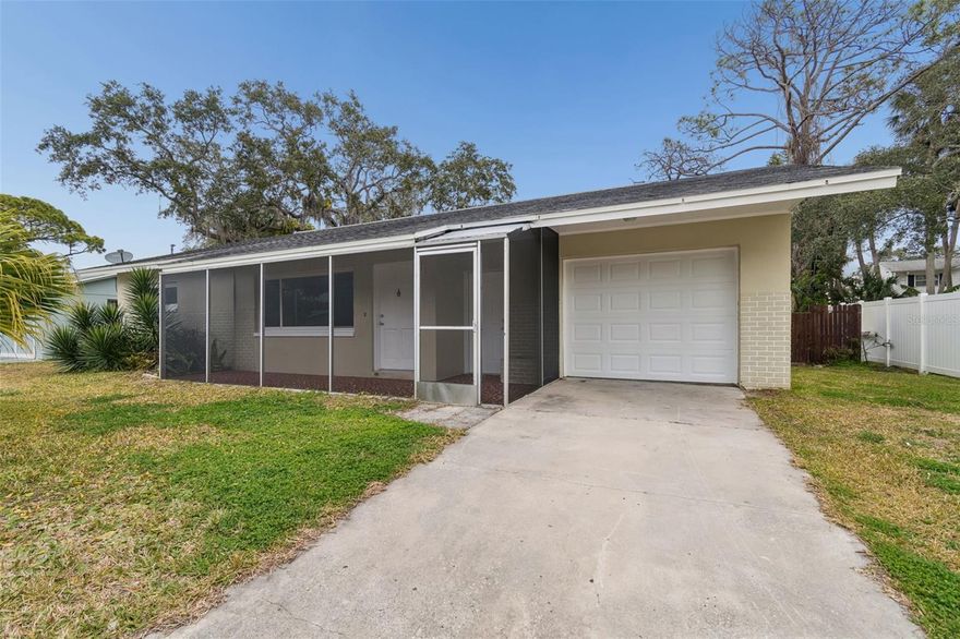 Charming and move-in ready 2-bedroom, 1.5-bath home featuring an oversized garage and fenced backyard. The beautiful open kitchen offers plenty of cabinets / counter space and a convenient breakfast bar. Tile flooring runs throughout the home, which offers both a living room and a separate family room highlighted by a cozy wood-burning fireplace. Enjoy relaxing on the screened-in front porch and embracing the Florida lifestyle. Conveniently located just minutes from vibrant Downtown New Port Richey, offering boutique shopping, dining, breweries, pubs, and live entertainment. The area is experiencing exciting growth with new restaurants, retail development, and the reopening of the historic Hacienda Hotel. Don’t miss this opportunity to own a home in one of New Port Richey’s most desirable and evolving areas. OWNER FINANCING OPTION AVAIABLE