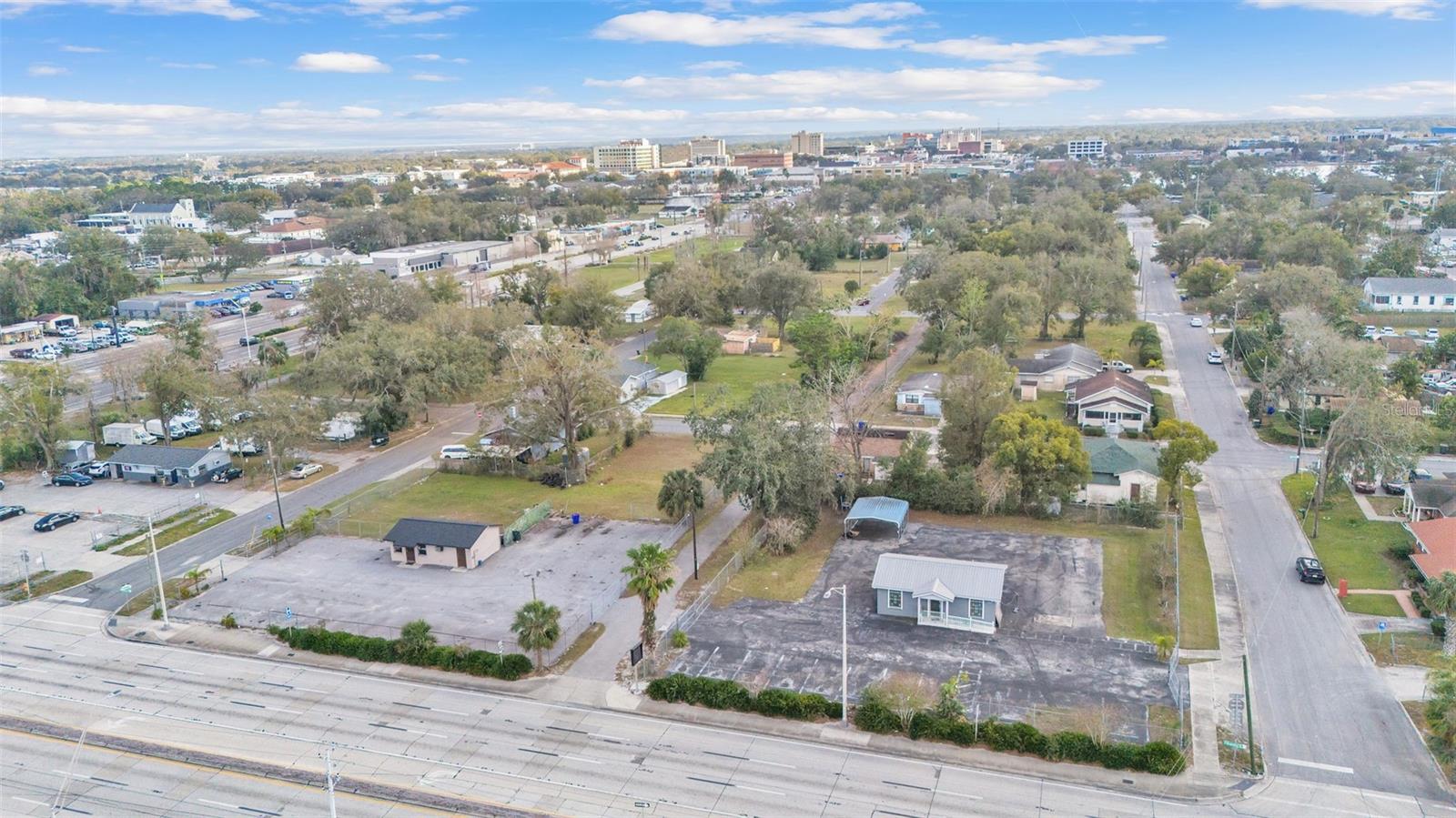 Looking for an exceptional commercial property that is zoned C-2 with versatile opportunities? Located next to the corner of Memorial BLVD and Florida AVE. in close proximity to a thriving downtown Lakeland and only minutes away from the local hospital and medical facilities. This unique listing consists of four parcels that include both business and residential income potential. Whether you are looking to extend your investment portfolio or you're an entrepreneur, this location has it all. Each parcel is fenced with on-site parking available. Zoning allows for a variety of retail, business, professional services, financial institutions, and a limited number of transient lodging facilities. Both residential properties are in need of renovations.
