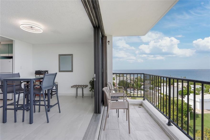 Step into this apartment and let the breathtaking views do the talking. Located on the 14th floor of the Torre de la Reina condominium, this 1,007 square foot residence features two bedrooms and one bathroom. The living room and kitchen have been updated with modern flooring, while the original parquet floors in the bedrooms have been preserved, adding warmth and timeless character. The remodeled kitchen and updated finishes complement the unit’s sleek feel, while sweeping panoramic views of Escambrón Beach take center stage. Brand-new hurricane-resistant sliding doors seamlessly connect indoor and outdoor living, and a new mini-split system enhances comfort in the living area. The apartment includes one designated covered parking space and the reliability of a full power generator. This gated community offers 24/7 security, a resort-style pool and gazebo, a designated car wash area, and an on-site coworking space known as District View—ideal for remote work or focused productivity. Enjoy exceptional proximity to the park and bike path, connecting directly to Old San Juan in one direction and Condado and Miramar in the other.