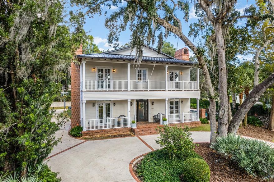 Elegant Charleston-style residence resting on an elevated lot across the street from lakefront residences with city owned lake access to Lake Osceola directly across the street. Premier location off Bonita Drive on a quiet, beautiful tree-lined brick street in the heart of Olde Winter Park. Oversized lot of .33 acres and 122 feet across the front of the property. Secluded dead-end street with only three neighbors. Gracious five-bedroom plus bonus room, five-bath home with a welcoming circular driveway. Wonderful floorplan with no wasted space. Downstairs enjoys a den and office or formal living room, plus a formal dining room, island kitchen open to gathering room and the fifth bedroom, and guest room off the bright two-story foyer provides sophistication with a wood-burning fireplace, new carpentry, tray ceiling, contemporary lighting and French doors leading to the covered porch. A formal dining room allows for seamless entertaining featuring beautiful built-ins. Spectacular chef’s kitchen of Skolfield Homes 2016 offers marble countertops, stainless steel appliances of Miele, Wolf and Sub-Zero, gas range with hood, built-in double oven, an oversized island and open eating space. Adjacent to the kitchen is the family room, with an abundance of windows and French doors, all overlooking the beautiful pool and brick patio. Downstairs guest/in-law suite with private bath, coffered ceilings and fireplace. Upstairs you will find the primary retreat with access to second floor balcony and a relaxing all new primary bath of Skolfield 2023 complete with dual sinks, glass shower, soaking tub and spacious walk-in closet. Three additional oversized, designer bedrooms and two full baths complete the upstairs. Wood floors, crown molding, top-of-the-line finishes can be found throughout this stunning home. Private shaded backyard offers several amenities including covered patio with summer kitchen and a tropical pool ideal for those hot Florida summer days. Air conditioners Trane and Nexia replaced in 2019. Rinnai gas water heater in 2022. All new interior paint, wallpaper in dining, office, powder bath, primary bath and guest bedroom. Interiors completed by Steele Street Designs. Surrounded by multi-million-dollar homes. Winter Park Chain consists of six lakes connected by navigable canals. Lake access via a city-owned lot across the street. Fishing public dock area to launch paddleboards, canoes and kayaks. Long driveway and roundabout are perfect for guests, multiple cars and parking. Ample storage spaces with under stairs closet, mud room, large hallway closet upstairs, attic and garage storage. Improvements list available upon request and attached to MLS. Home is "staged only" and ready for a flexible and fast closing.