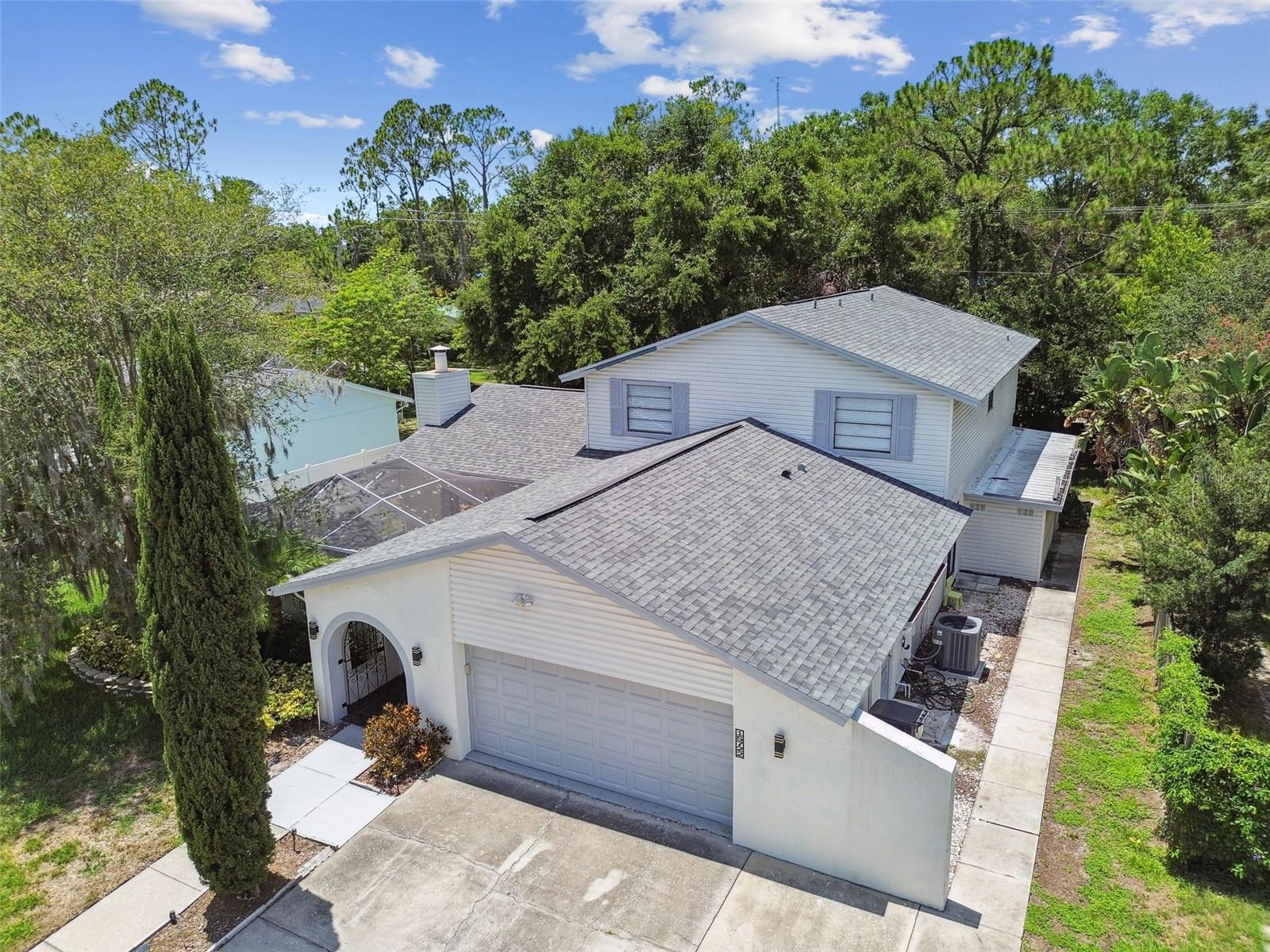 This exceptionally renovated 5-bedroom, 3-bathroom, 2-car garage home offers over 3,500 sq. ft. of thoughtfully designed living space in the heart of Carrollwood, one of Tampa’s most desirable and established neighborhoods. Expertly renovated—perfect for those seeking a move-in ready, spacious home or investors looking to capitalize on short or long term rentals with a strong rental history at a $6,300/mo.
Tucked away on a quiet street, this home welcomes you with a classic arched entryway. Inside soaring ceilings and natural light pours in through oversized windows overlooking a private screened courtyard. Marble flooring throughout the first level adds elegance while staying cool, low-maintenance, and allergen-resistant. The spacious living room is designed for both comfort and entertaining, with vaulted ceilings, wood-burning fireplace, and dual sets of French doors leading to a courtyard and Florida room. At the heart of the home is a stunning, Italian-imported kitchen that blends sleek design with everyday functionality. A spacious island invites you to gather, while the adjacent dining area makes entertaining a breeze-whether you are hosting weekend brunch, holiday dinners, or casual evenings with wine and conversation. This chef-worthy space features stainless steel appliances, beautiful countertops, custom cabinetry, stylish backsplash, and a walk-in pantry that offers storage to keep your space organized and clutter-free. A large sliding door opens to the side yard—perfect for seamless indoor-outdoor living. The first floor also offers two generously sized bedrooms, renovated full bath, and a spacious laundry room. One bedroom opens to the Florida room, ideal for guests or home officeUpstairs, the luxurious primary suite features a peaceful retreat with a large walk-in closet and spa-like en-suite bath with dual vanities and dual rain shower heads. The second floor also includes two more bedrooms, a stylish third bath, new luxury wood-look vinyl flooring, and a flexible bonus area—perfect for movie nights, a playroom, or a home office. Enjoy peace of mind thanks to a full renovation, including a new roof (10-year warranty), new HVAC (transferable warranty), updated plumbing, and electrical. Located in a non-flood zone and non-evacuation zone, this home offers true worry-free living. Just minutes from I-275 and the Veteran’s Expressway, you’re only 15 minutes from Tampa International Airport and downtown. Top attractions like Busch Gardens (20 mins), Walt Disney World, and Universal Orlando (1.5 hrs) are close by, along with shopping, dining, and top-rated schools.