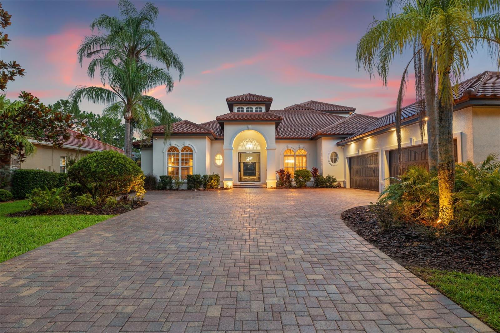 Welcome to one of Westchase’s most coveted gated enclaves within the Tree Tops community - where Luxury, elegance, and tranquil living come together in a serene, private setting. This stunning custom-built pool home is complete with 4 bedrooms, 6 full bathrooms, a designated home office that can easily be served as a 5th bedroom, and an expansive layout that blends refined finishes with thoughtful functionality. Boasting over 4,000 square feet of living space and situated on a premium lake-front lot, this residence is a true architectural masterpiece that combines indoor comfort with impressive outdoor amenities. As you approach, a brick-paved driveway leads to a 4-car side-entry garage with epoxy flooring, offering both curb appeal and stylish ample space for vehicles and storage. A unique custom glass pivot entry door sets the tone for the luxurious interiors beyond. Inside, you’re greeted by Luxury vinyl plank flooring, a welcoming living room with a soaring tray ceiling, extensive crown molding and tranquil water views. The formal dining room and formal living room provide elegant spaces for entertaining, while the family room features custom built-in entertainment center, stunning pool and lake views with effortless flow into the heart of the home—an exceptional gourmet kitchen designed to impress. This chef’s dream kitchen showcases two oversized islands, Quartz countertops, a striking marble backsplash, a gas cooktop, custom hood, solid wood cabinetry, and an expansive walk-in pantry with custom wine fridges that can hold up to 500 bottles—perfect for entertaining on any scale. Step outside to your own private retreat - a covered lanai with an outdoor kitchen, gas grill, spa, gas fireplace, and hot tub that invites year-round relaxation. This enclosed pool area offers resort-style ambiance, enhanced by peaceful water views and lush tropical landscaping. Whether you're hosting gatherings or enjoying quiet evenings, this space truly brings the indoors out. The first-floor primary suite is a sanctuary, featuring serene water views, and a spa-like ensuite bath complete with a slipper soaking tub, custom walk-in steam shower, double Quartz vanity, and 2 walk-in closets with custom shelving. The dedicated home office with built-in bookshelves offers privacy and flexibility—ideal for working from home or converting into a 5th bedroom and boasts and walk-in closet with custom shelf organizing system. Three additional bedrooms, including a private guest suite with direct pool access, providing comfort and privacy for family or visitors, each served with upscale finishes and custom lighting. Upstairs, a spacious bonus/media room opens onto a screened-in covered balcony, the perfect setting for morning coffee or sunset cocktails while overlooking the water. Whether it becomes a home theater, game room, or additional guest space, the versatility is unmatched. Additional highlights include a large laundry room with utility sink and additional storage cabinets, custom storage solutions throughout, in-ceiling surround sound, designer custom light fixtures, and a layout tailored to everyday living. The new tile roof was just installed in 2025! Located just 20 minutes from Tampa International Airport, with easy access to downtown Tampa, top-rated Gulf beaches, and the area's best specialty dining and shopping, this home delivers both Luxury and a polished lifestyle in one place.
