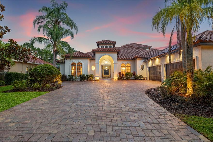 Welcome to one of Westchase’s most coveted gated enclaves within the Tree Tops community - where Luxury, elegance, and tranquil living come together in a serene, private setting. This stunning custom-built pool home is complete with 4 bedrooms, 6 full bathrooms, a designated home office that can easily be served as a 5th bedroom, and an expansive layout that blends refined finishes with thoughtful functionality. Boasting over 4,000 square feet of living space and situated on a premium lake-front lot, this residence is a true architectural masterpiece that combines indoor comfort with impressive outdoor amenities. As you approach, a brick-paved driveway leads to a 4-car side-entry garage with epoxy flooring, offering both curb appeal and stylish ample space for vehicles and storage. A unique custom glass pivot entry door sets the tone for the luxurious interiors beyond. Inside, you’re greeted by Luxury vinyl plank flooring, a welcoming living room with a soaring tray ceiling, extensive crown molding and tranquil water views. The formal dining room and formal living room provide elegant spaces for entertaining, while the family room features custom built-in entertainment center, stunning pool and lake views with effortless flow into the heart of the home—an exceptional gourmet kitchen designed to impress. This chef’s dream kitchen showcases two oversized islands, Quartz countertops, a striking marble backsplash, a gas cooktop, custom hood, solid wood cabinetry, and an expansive walk-in pantry with custom wine fridges that can hold up to 500 bottles—perfect for entertaining on any scale. Step outside to your own private retreat - a covered lanai with an outdoor kitchen, gas grill, spa, gas fireplace, and hot tub that invites year-round relaxation. This enclosed pool area offers resort-style ambiance, enhanced by peaceful water views and lush tropical landscaping. Whether you're hosting gatherings or enjoying quiet evenings, this space truly brings the indoors out. The first-floor primary suite is a sanctuary, featuring serene water views, and a spa-like ensuite bath complete with a slipper soaking tub, custom walk-in steam shower, double Quartz vanity, and 2 walk-in closets with custom shelving. The dedicated home office with built-in bookshelves offers privacy and flexibility—ideal for working from home or converting into a 5th bedroom and boasts and walk-in closet with custom shelf organizing system. Three additional bedrooms, including a private guest suite with direct pool access, providing comfort and privacy for family or visitors, each served with upscale finishes and custom lighting. Upstairs, a spacious bonus/media room opens onto a screened-in covered balcony, the perfect setting for morning coffee or sunset cocktails while overlooking the water. Whether it becomes a home theater, game room, or additional guest space, the versatility is unmatched. Additional highlights include a large laundry room with utility sink and additional storage cabinets, custom storage solutions throughout, in-ceiling surround sound, designer custom light fixtures, and a layout tailored to everyday living. The new tile roof was just installed in 2025! Located just 20 minutes from Tampa International Airport, with easy access to downtown Tampa, top-rated Gulf beaches, and the area's best specialty dining and shopping, this home delivers both Luxury and a polished lifestyle in one place.