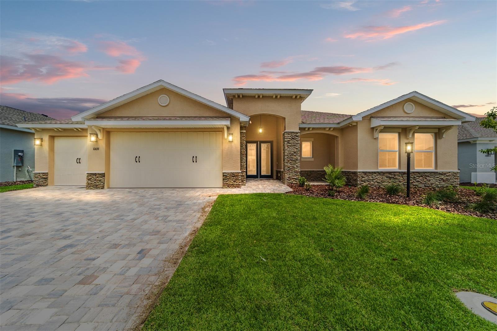Live in luxury and style in this brand-new Wellington model, featuring an open concept layout, gourmet kitchen, and seamless indoor-outdoor living in the Balfour neighborhood of On Top of the World. This 3-bedroom, 3-bathroom home offers tile flooring and tray ceilings throughout, creating a bright and elegant living space. French entry doors add sophistication, while sliding doors in the living area lead to a screened lanai, perfect for entertaining or relaxing outdoors. The gourmet kitchen is equipped with a large island, quartz countertops, tiled backsplash, under-cabinet lighting, staggered cabinets with crown molding, a built-in oven and microwave, and a 5-burner cooktop. A separate dining area with elegant lighting provides the perfect space for family meals or entertaining guests. The master suite is a true retreat, featuring a tray ceiling, spacious walk-in closet, and a luxurious en suite with dual sinks and a zero-entry tiled shower with a built-in bench. Completing this home is a 3-car garage, offering ample space for vehicles and storage. Located in the vibrant On Top of the World community, residents enjoy resort-style amenities and an active, engaging lifestyle — all in a brand-new, move-in-ready home. Call for your private showing today!