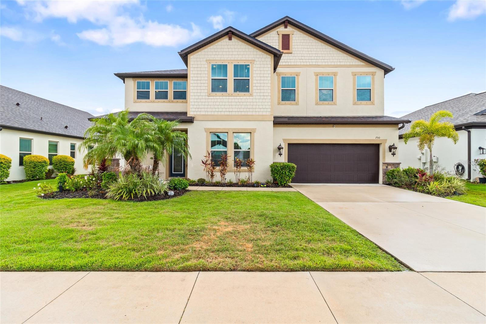 Welcome to this EnergyStar-rated, 5-bedroom, 4-bathroom home with a screened in lanai, nestled in the charming community of Raven Crest. With a low HOA and no CDD fee, this property offers both comfort and value. This is truly a multigenerational home. The front door has been enhanced with elegant glass, creating a warm and welcoming first impression and an abundance of natural light flowing throughout the entire house, creating a bright and inviting atmosphere. The large Gourmet kitchen showcases a double oven with an oversized island adorned with enriched pendant lighting, stainless steel appliances, and a walk-in pantry. The butler's pantry was redesigned with a wine cooler and stylish wood accent wall. Enjoy casual meals in the cozy eat-in kitchen area and host elegant dinners in the separate dining room. The home features a brand new roof, new lifetime stain-resistant carpets (2nd floor), painted doors and stair rails in sleek dark colors, wood accent walls in two bedrooms, and updated light fixtures in 2 full bathrooms and bedrooms. Extra storage is available under the stairs, and the garage offers complete overhead storage. The home is equipped with numerous energy-efficient windows, doors, and glass sliding doors, all of which are accompanied by complete spray foam-insulated walls and attic. The outdoor living area offers an updated patio with a 72" outdoor fan, making the backyard lanai ideal for watching breathtaking sunsets overlooking the lake view. Additional features include a bonus room upstairs for a home office, playroom, or extra living area. New washer and dryer! Experience the perfect blend of modern updates and classic charm in this exquisite Raven Crest home. Don’t miss the opportunity to make it yours!