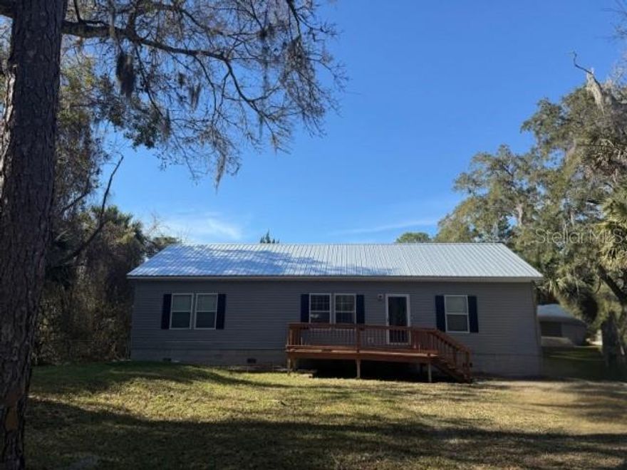 Welcome to peaceful living in the community of Venetian Isles. This 3-bedroom, 2-bath home features a brand new roof and backs to Brown Creek a protected national preserve, offering beautiful natural views and added privacy. Just down the street, the Intracoastal Waterway enhances the serene surroundings of this location. Inside, you’ll find an open floor plan with ceramic tile flooring and a spacious kitchen complete with stainless steel appliances, including a refrigerator, range, wall oven, built-in microwave, and upgraded hood vent. A wrap-around center island and ample cabinetry provide plenty of storage and prep space. The separate laundry room includes a washer and dryer for added convenience. Outdoor living shines here with a welcoming east-facing front porch perfect for enjoying sunrises, along with a large elevated Trex deck that wraps around an above-ground pool, ideal for relaxing or entertaining on warm Florida days. The backyard overlooks the creek and preserve, creating a peaceful setting to enjoy evening sunsets. Two large decks, front and back, extend your living space outdoors. The primary suite offers generous space with a walk-in closet and an en suite bath featuring double vanity sinks, a garden tub, and a separate shower. All bedrooms include walk-in closets for excellent storage. A detached shed with electricity, window A/C unit, and water access provides additional flexibility for hobbies or storage. Situated on a .26-acres with no HOA restrictions, you have the freedom to bring your RVs and recreational equipment. The home is on well and septic with a privately owned water softener, helping keep utility costs down. Short-term rentals are allowed, and the property is located within a USDA-eligible lending area. If you’re seeking peaceful surroundings with natural views and no restrictions, this could be the perfect place to call home.