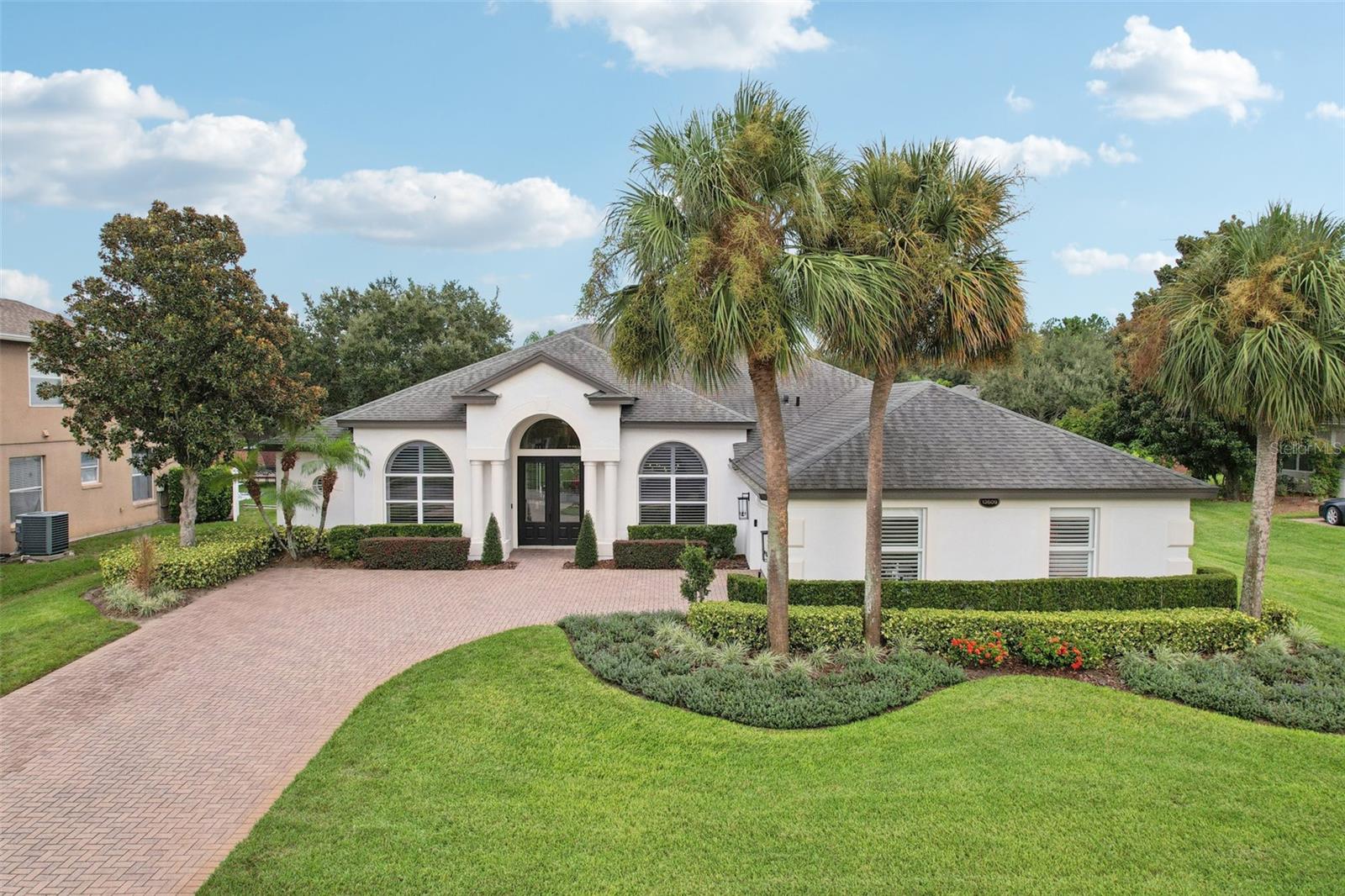 Stunning Executive Home in Gated Glynwood – One-of-a-Kind Custom Renovation! This modern masterpiece is based on the popular MI Homes Calabria floor plan but has been reimagined with over $170,000 in custom upgrades. Step inside to discover a bright, open-concept layout designed for both luxury and functionality featuring glue down Engineered white oak hardwood floors throughout main living areas and primary suite. Modern tile in baths with carpet only in three secondary bedrooms. The Chef's dream kitchen with all NEW Custom slow-close cabinetry to the ceiling with glass-lit uppers offers Quartz countertops with waterfall island, all NEW appliances including FORNO deluxe range and 60” professional refrigerator, pot filler, custom backsplash, under-cabinet lighting and under counter island microwave. Gold hardware for a chic, contemporary finish. Spacious family room boasts a custom media wall with lower built ins. The living room opens to the kitchen and family room for seamless flow of entertaining and features dramatic 13’ double tray ceiling and designer accent wall. Formal dining room with 12’ tray ceiling offers detailed wood accent insets with crown molding and a custom wine alcove tucked around the corner for effortless entertaining. Private office is conveniently located off the foyer with 8’ French doors and 11’ ceiling with custom trim moldings and desk area. The Primary Suite is King-sized with tray ceiling and sitting area and features a totally updated Luxurious en-suite bath that includes free-standing tub with accent wall, oversized shower, dual vanities with custom lighting and 2 walk-in closets. Bedroom 2 and fully renovated pool bath are tucked at the rear for privacy. Bedrooms 3 & 4 with shared updated bath are located in another private wing. The laundry room features upper/lower cabinetry (plumbed for laundry sink) and the washer/dryer are included. The garage is amazing for storage and car space featuring freshly painted interior, custom lighting, custom garage floor tiles and 2 plantation shuttered windows for natural light. Massive screened lanai with multiple seating areas boasts resurfaced pool and spa (pool features pop up in-ground cleaning), ample patio space for dining, relaxing, and entertaining as well as a gas fire pit. Recent Upgrades & Major Features: 2025..All New kitchen, New interior solid core doors including trim molding and baseboard. New interior lights from Restoration Hardware and Arhaus. New exterior lights and fresh interior and exterior paint in late 2024/2025. Pool deck resurfaced and new pool pump. In 2024: Pool/spa resurfaced to include new tile surround, udated landscaping and new backflow. New water heater and pool enclosure re-screened 2023. New plantation shutters throughout 2022. Washer and Dryer 2021. Irrigation fully updated 2020. Solar for pool/spa 2019. Pool heater 2018. New Roof 2017. Trane AC 2014. Underground propane tank fuels the firepit and pool heater. As part of the Stone Crest community, Glynwood residents enjoy access to a clubhouse, community pool, tennis/pickleball courts, playground, and a scenic walking trail around a tranquil pond. Location, location, location! Just a short walk to Winter Garden Village, you'll find shopping, dining, banking, AdventHealth Hospital, and more—plus easy access to Hwy 429 and the Turnpike for stress-free commutes to downtown Orlando, the airport, and major attractions. Don’t miss your opportunity to own this exceptional property.