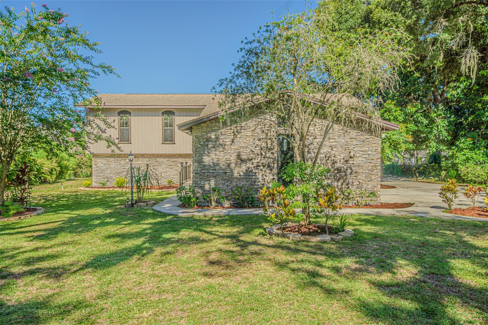 Welcome to your Florida dream retreat—spacious, serene, and full of income-generating potential! This meticulously maintained estate offers nearly 4,000 sq ft of elegant main living space plus a separate 800+ sq ft fully equipped in-law suite with its own private entrance—ideal for extended family, multi-generational living, or potential rental income with total privacy. Nestled on a lush, fertile lot perfect for tropical fruit and organic vegetable gardening, this home invites you to grow mangoes, jackfruit, papaya, moringa, and more right in your backyard. The open-concept main home features a chef’s kitchen with granite countertops, a large island, stainless steel appliances, and a custom coffee bar, flowing into a bright sunroom with French doors—perfect as an office, gym, or future bath. Luxury touches abound, including teak and exotic hardwood floors, crown molding, 5" baseboards, and custom window treatments. Enjoy peace and privacy with no HOA, a wide garage, upgraded irrigation, and major system updates: Roof (2018), HVAC (2020), Septic & Well Pump (2020), and appliances through 2023. Located minutes from top-rated schools, shopping, major highways, and nature spots, this property is more than a home—it’s a flexible lifestyle and income opportunity. Don’t miss this rare gem—schedule your private showing today before it's gone!