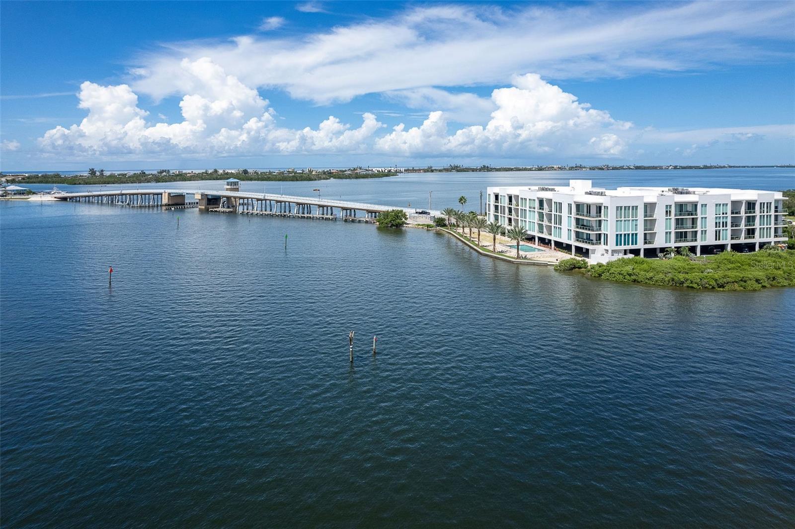 TOP FLOOR, SPECTACULAR VIEWS, BOAT SLIP #30, ONE MILE TO THE BEACH - Enjoy the Gulf Coast lifestyle at Redfish Key Villas with easy access to the beaches of Manasota Key, Palm Island and Boca Grande. Experience world class fishing, boating, golfing and dining in the heart of Englewood and surrounding villages of Venice and Boca Grande. There is nothing quite like Redfish Key Villas with its unique setting at the water’s edge, superior construction, modern design, and upscale residences. This top floor, open-concept, split plan residence delivers a luxury lifestyle like no other. Prepare to be wowed by twelve-foot ceilings and incredible views of Lemon Bay and Redfish Cove. Ten-foot, hurricane impact resistant windows and sliding glass doors allow natural light to pour in. The interior finishes include tile flooring in the main living areas, custom wood cabinetry with granite tops throughout, and luxury stainless appliances. Relax on your private balcony and enjoy endless views of osprey, dolphin, and manatee. Lounge by the heated pool or walk to local beaches, shops and restaurants. This stunning residence is ready for immediate enjoyment and includes assigned boat slip #30. Do not miss this opportunity!