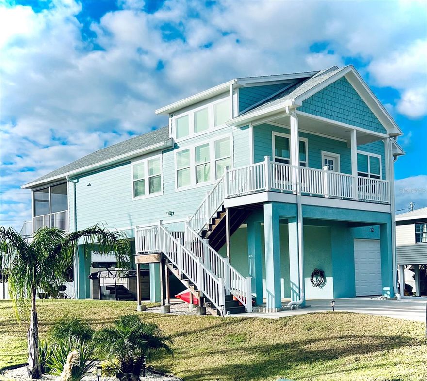 No work required! Practically new, completely furnished, turnkey beachside home.   You are a suitcase away from relaxing on the beach, golfing, kayaking or fishing.  Splash in the new swim spa.  Swim, float or hang out in the hammock.  Use the beach bikes, or paddle boards.  Even the towels are included. This 3/2 bath home is located in a safe residential beach community.  Walk or bike to the beach on a quiet residential street with dedicated access at end of street.  The uncrowded beach has miles of soft sand to explore, with no cars, crowds, or traffic.  Good surfing, swimming and fishing.  No HOA.  Short term vacation rentals allowed.  This 2 story stilt home features soaring vaulted ceilings and a great room design.  3 bedrooms on the main level with luxury vinyl flooring throughout, light bright colors, impact rated doors and windows.  Low maintenance hardi siding, trex decking and tons of parking.  The kitchen features porcelain countertops, soft close cabinets with pullout shelves,  a 5 burner cooktop with double oven, and stainless appliances.  Primary suite has 8x10 walk in closet, private bath with tile floors and large shower.  Dual vanity with quartzite tops and stainless fixtures.  2 guest bedroom and 2nd bath on this level.  Ground level has 18x24 heated and ac "man cave" game room.  Built in 2023 home features include: Hurricane rated impact windows and doors, luxury vinyl flooring, plantation shutters, remote controlled blinds, porcelain and quartzite countertops, designer level appliances, trex decks, swim spa, fully furnished, multiple parking spots, vinyl fencing, and "stubbed" in for an added bath on first level.  Oversized one car garage and extra parking with large carport and concrete driveway parking. Sunny back deck with outdoor shower and screened covered deck off kitchen and bedroom.   There is also a pre-wired location for elevator lift off rear deck.  Beach allows dogs.  Great home for full time living, vacation home, or short term rental income.