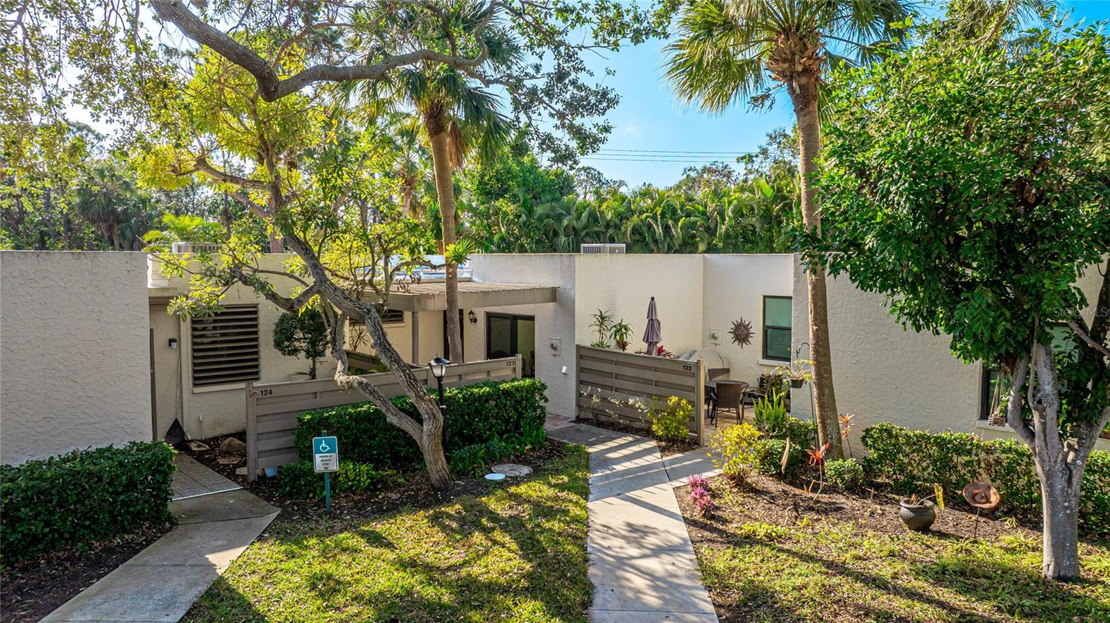 Spacious First-Floor Corner Condo with Serene Pond Views. This exceptionally spacious first-floor corner unit offers 1,818 square feet of comfortable living in a peaceful, park-like setting. With three bedrooms and two and a half bathrooms, this condo provides ample space for relaxation and entertaining. The private front courtyard welcomes you into the home, while a second courtyard in the back offers additional outdoor living space with tranquil pond views. The primary bedroom features a walk-in closet, an en-suite bathroom, and sliding doors leading to the enclosed lanai.Recent updates include a new HVAC system installed in November 2022, a new front door, new windows in the living room and hallway, and a new sliding door. The convenience of an in-unit washer and dryer adds to the ease of living. One assigned carport space is included.This beautifully maintained community spans 88 acres and is recognized as an Audubon bird and wildlife sanctuary. Lush tropical landscaping enhances the natural beauty of the surroundings, creating a peaceful retreat. Experience the perfect blend of space, privacy, and scenic views in this remarkable condo.