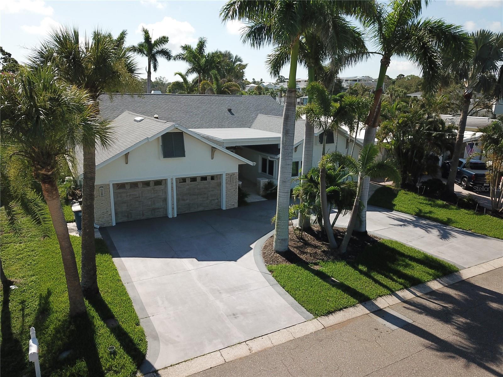 WATERFRONT OPPORTUNITY! This remarkable 3,118 sq. ft. Clearwater waterfront home was a true showpiece—offering luxurious indoor/outdoor living, tropical landscaping, and resort-style amenities. Unfortunately, the home sustained flooding due to Hurricanes Helene and Milton and is now in need of repair and restoration. This is your chance to bring it back to life or create something entirely new on a premium waterfront lot with 70 feet of seawall. The property includes valuable features still intact, including a new dock (2023) with 13,000 lb. boat lift, tiki hut, gas-heated saltwater pool and spa, and spacious circular driveway lined with royal palms. Hurricane impact windows, a 2022 roof, and newer mechanicals (including 2 AC units from 2019 and pool heater from 2022) may offer salvageable value for the right buyer. Previously renovated with vaulted ceilings, multiple en-suite bedrooms with walk-in closets, and elegant details throughout—this home offers endless potential to restore or reimagine a luxury waterfront lifestyle. Whether you're an investor, builder, or buyer ready to take on a renovation, don’t miss this rare opportunity to secure a prime piece of Clearwater waterfront real estate. Appointment required. Cash or renovation financing only.