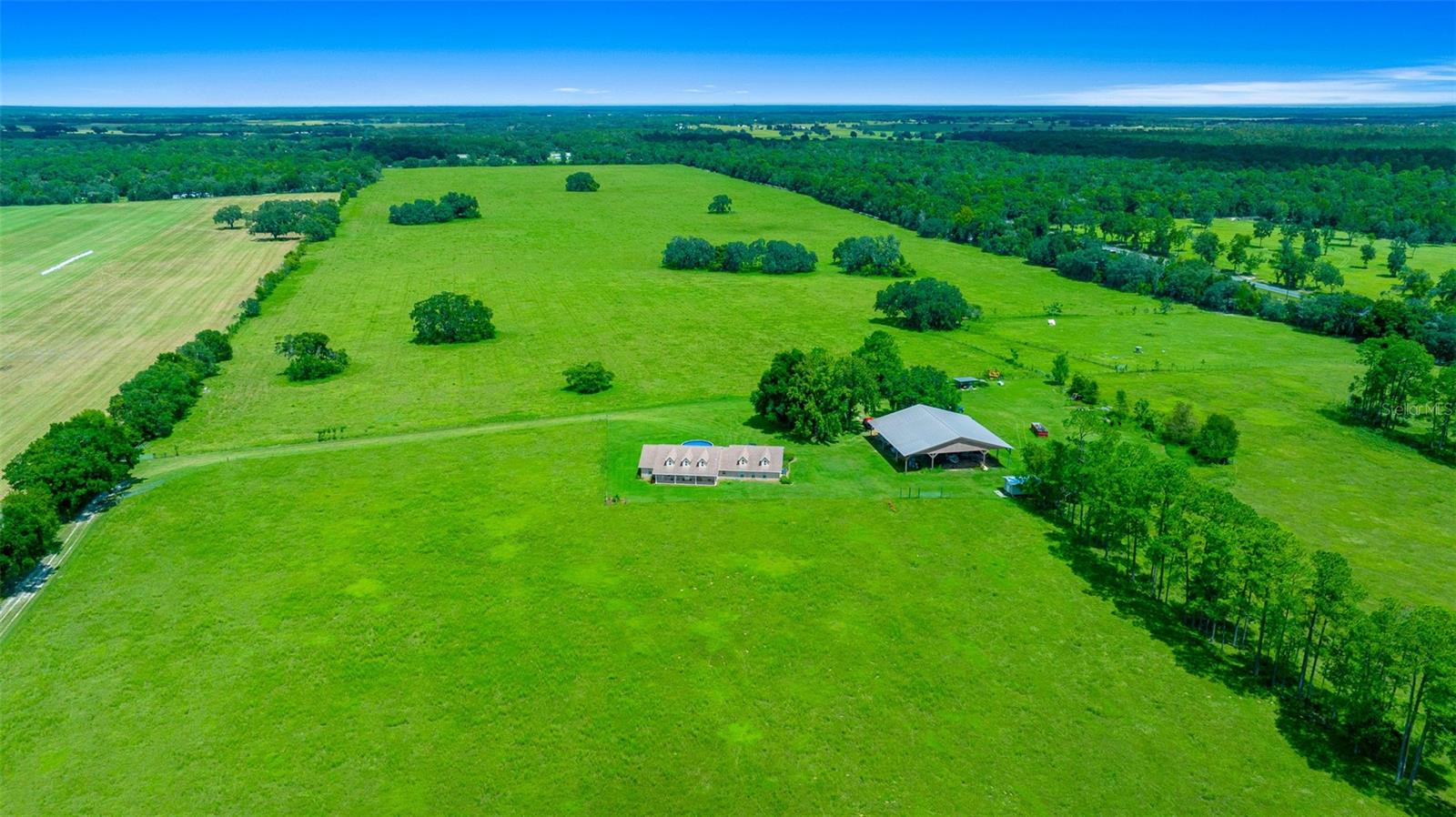 LESS THAN $19,000 AN ACRE!! Views like none other! At 159.25 acres, the opportunities are seemingly endless for this beautiful farm! Situated perfectly at top of a hill, the views from the residence are breathtaking with most of the farm being visible from the front and back porches. The property is perimeter fenced and cross fenced in several areas however the majority of the property is a blank canvas providing the buyer with the options to create their dream farm set up with plenty of space to add a track, barns, multiple paddocks and riding ring. The home is complete with four bedrooms and three baths, including a spacious primary, a large den/bonus room great for entertaining as well as an open floor plan. A large pole barn with electric and an enclosed workshop rounds out this beautiful and rare farm.