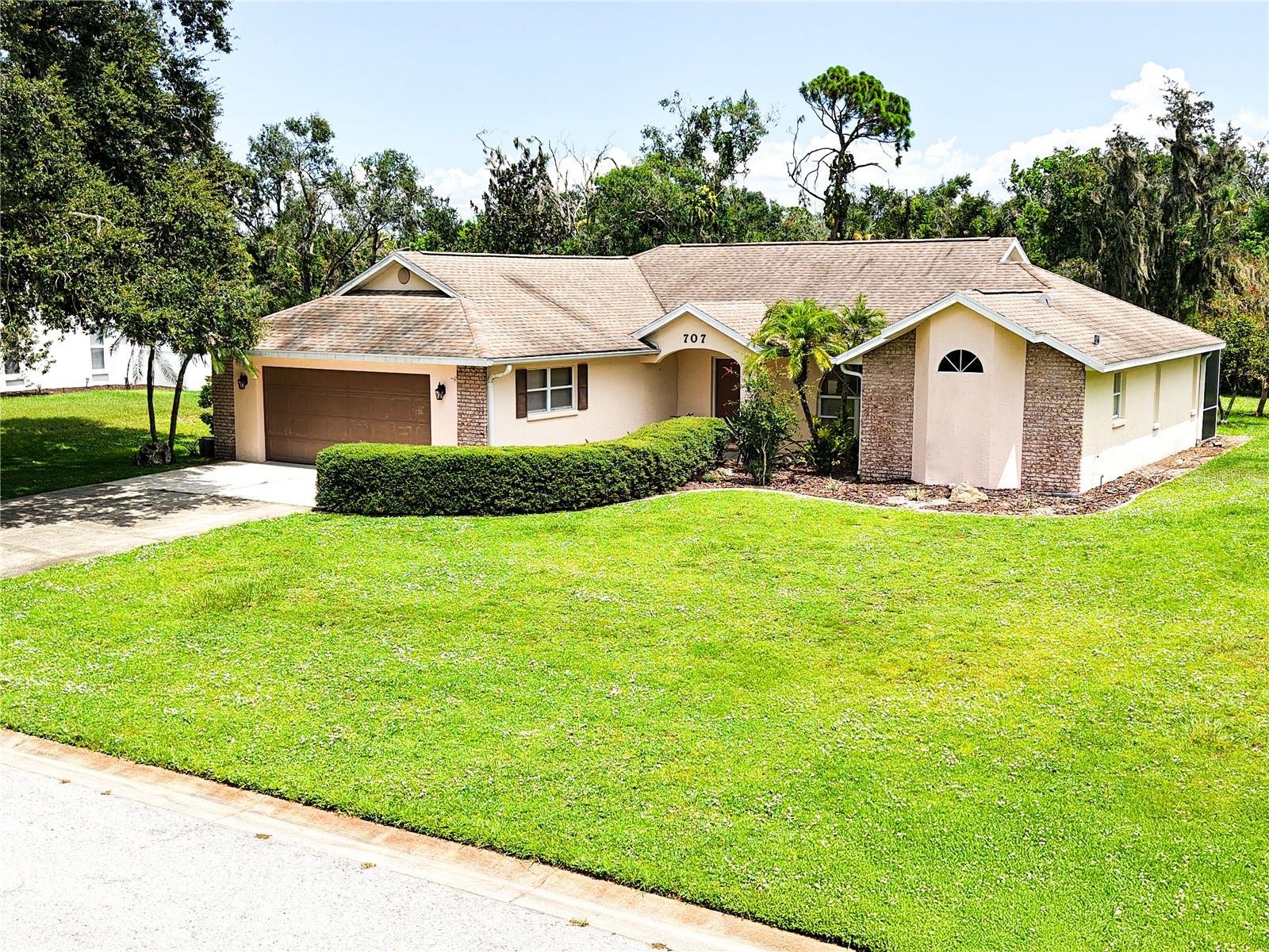 Welcome to your new home in the desirable Mill Creek community of Bradenton, Florida. This charming 3-bedroom, 2-bathroom residence at 707 133rd St E offers 1,716 square feet of open, light-filled living space on a rare and spacious half-acre lot. Unlike most new construction homes where the lots are the size of a postage stamp and you can practically reach out your window and touch your neighbor’s house, this property offers true breathing room, privacy, and space to enjoy the outdoors.
Inside, you'll find vaulted ceilings, a large living area, and an updated kitchen with ample cabinetry and modern appliances—ideal for both everyday living and entertaining. The primary suite includes two walk-in closets and a private en-suite bathroom with a spa tub and walk in shower. The home features solid wood and tile flooring throughout for easy maintenance. The laundry is currently utilizing an interior hook up but can be relocated to the garage to use the room as a small den or office. The attached two car garage offers plenty of storage.
Step outside to enjoy Florida living on the screened lanai overlooking the expansive yard with access to Mill Creek — perfect for relaxing, grilling, or hosting friends and family!
Mill Creek is a quiet, deed-restricted neighborhood. It’s just minutes from Lakewood Ranch, top-rated schools, shopping, dining, and Gulf Coast beaches.