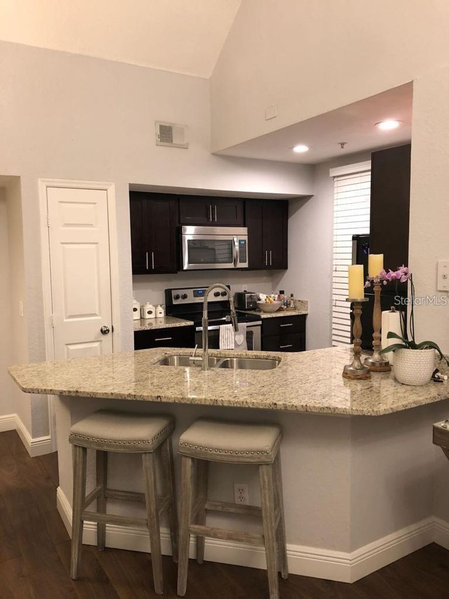 This is a beautiful end unit, ground floor access to a spacious apartment on the second floor it has a loft, makes a great office or study or additional bedroom. Apartments has stainless steel appliances, granite countertops and renovated bathrooms. Great location, next to super market, near Universal theme parks, Millennia Mall and Downtown with easy access to I-4. Gated community, amenities include gym, pool access. HOA Approval required.