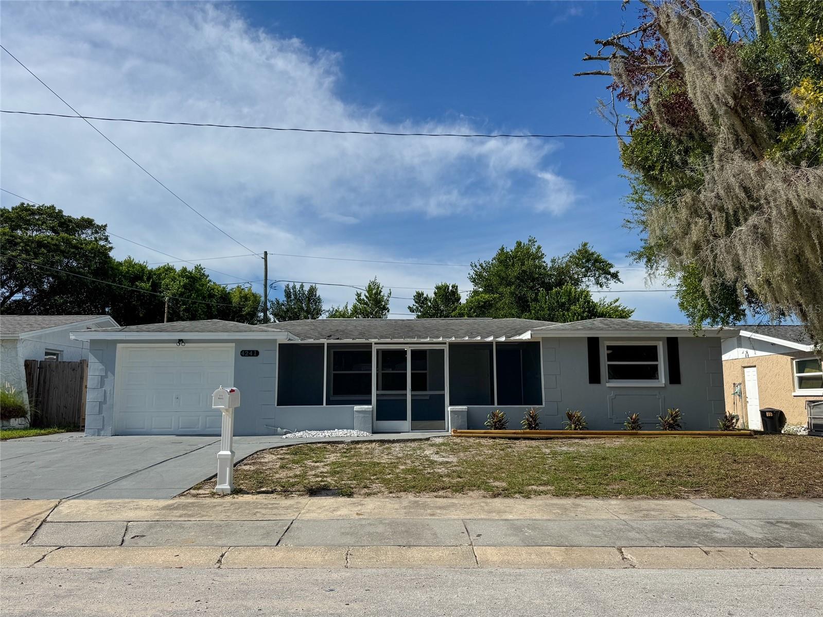 Freshly renovated, rare 4 bedroom, 2 bath home with a garage and large fenced yard in desirable Holiday NOT in a flood zone! Bring all offers as Seller will contribute to Buyer Closing Costs & Prepaid with acceptable offer! This home boasts tons of recent updates. New luxury vinyl plank throughout the property for easy maintenance. New paint inside and out, new modern lighting and ceiling fans, new 6 panel doors , new bathrooms along with newer energy efficient vinyl double pane windows. Newer solid wood kitchen cabinets with subway tile backsplash and brand new stainless steel appliances! Before you even enter the front door, you are greeted by colorful landscaping and a large front screened in porch to enjoy you days and nights. As you enter the front door, you will be greeted by the spacious living room which transitions to a dining area off the kitchen that features brand new stainless steel appliances. A 30 year dimensional shingle roof was installed Nov. 2016, a new central HVAC December 2020, a new hot water heater 2025, and a brand new leach field in 2023 so your major ticket items are taken care of for many years. The 4th bedroom can either be used as a bedroom as it has a built-in closet or it is big enough to be used as a family room or den. You have laundry hookups in the garage and a newer garage door. Outside you have a nice sized yard out front with a mature tree for shade and you can enjoy your days and evenings in the large fenced backyard with 6 foot privacy fence mature landscaping for even more privacy! The property is located in desirable Holiday and is just minutes from great restaurants, plenty of shopping, and several beautiful parks and a quick ride to Tampa or the beaches! There is NO HOA, NO Deed Restrictions, and NO Flood Insurance required. This home would be great for a 1st time buyer, vacation home, or even move-in ready rental home!