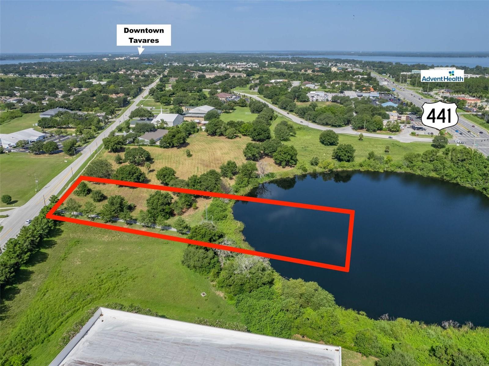 Multi-Family / Commercial Opportunity - 1.75+/- Acres (1.2+/- acres uplands) on Crown Lake fronting Dora Ave & visible from US Hwy 441. Site adjoins the Kohl's shopping Plaza on US Hwy 441. Location is mix of busy retail, commercial and medical professional with award winning AdventHealth Waterman Hospital just a few blocks away. Located within the city of Tavares & minutes to the Lake County Courthouse and other government offices. Property is zoned RMF 2 / residential multi-family 12 units per acre with water and sewer available. All information is believed to be accurate and correct but not guaranteed or warranted and subject to change without notice