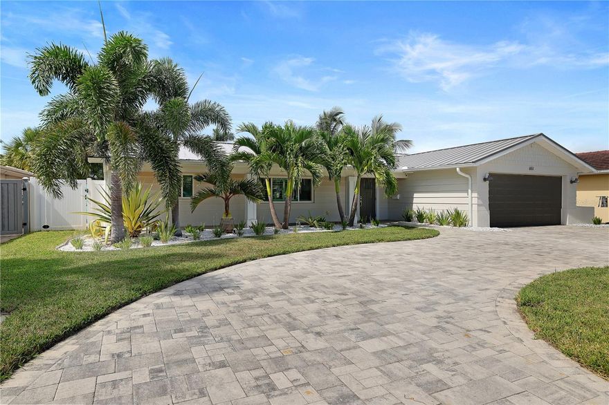 Completely remodeled waterfront beach home in the highly sought after Three Palms Point neighborhood on St Pete Beach!! As soon as you walk in the door, you see an amazing open water view. Gorgeous remodeled kitchen with marble countertops, large island and peninsula for extra seating, stainless steel appliances, and white solid wood shaker cabinetry. This completely open floor plan includes wood plank tile,  a wine bar, waterfront dining room, and plantation shutters on all the windows. Both bathrooms have been remodeled. The outdoor area is your private oasis, gorgeous OPEN waterfront views as well as privacy for the pool and hot tub. Travertine paver patio, with a pool and spa that was built in 2020, a charming cabana area, upgraded built in propane fire pit area and white vinyl fencing. Boaters will appreciate the composite dock with a 16,000 lb boat lift, providing easy access to Boca Ciega Bay and the intracoastal waterway. Additional highlights include a two car garage with epoxied garage floor with additional parking for multiple cars in the circular driveway with pavers. Brand new upgraded A/C system (2024), hurricane-resistant windows, large impact rated sliding glass doors and a tankless water heater ensure comfort and efficiency. Brand new metal roof completed in 2025. This fabulous waterfront retreat is luxury living in a coastal paradise. Beautiful St Pete Beach offers great shopping, gourmet restaurants and coffee shops. It is conveniently located with easy interstate access and within 20 minutes of Downtown St Petersburg, 40 minutes of Tampa International airport. Come and see this slice of paradise today, the pictures don't do the breathtaking view justice! Must see in person!
