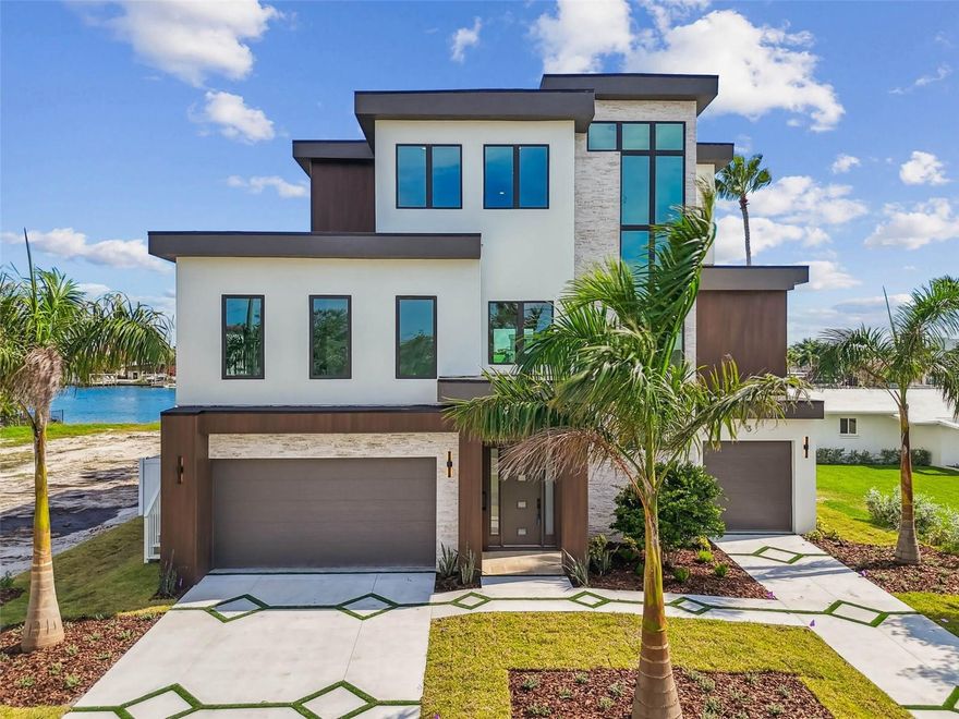 No - you didn’t misread this - this DREAM home is actually listed UNDER $900/sq ft for WATERFRONT NEW CONSTRUCTION. Go ahead and take a look around, you won’t find many other BRAND NEW homes priced as competitively as this! Introducing 3 Treasure Lane, a stunning luxury waterfront property in the heart of Treasure Island, FL. This incredible single-family home is situated right off the Treasure Island Causeway, offering breathtaking views of the water from almost EVERY room. Build your DREAM backyard oasis on this 15,155 sqft lot (75 ft width x 195 ft depth) with the ability to also add a pool house or pickleball court or whatever your heart desires! Go ahead and take a look around, you won’t find many lots as large as this on the water! This 3-story masterpiece with your own elevator spans an impressive 3,844 square feet of heated living space, with a total of 6,502 square feet to play with. You'll have plenty of room to spread out with 4 spacious bedrooms, an office, and 4.5 bathrooms - perfect for a growing family or for entertaining friends and loved ones. And with a double designer driveway and oversized garage featuring 3 garage door entrances, you can easily fit more than 6 cars and still have plenty of space to spare. The epoxy-treated flooring is a nice touch, too - no more worrying about stains or damage! But it's not just about the space - it's about the lifestyle. This home is intentionally positioned forward on the lot which allows for ultimate privacy from boaters passing by, as well further insulation from rising waters during hurricanes. Since some neighboring homes were damaged in the storms, there are other new construction builds being constructed on the same street. Enjoy instant equity once those homes are built. With the added tariffs, building costs have increased, making this home an even greater value. To rebuild the same home, it would likely cost about 10-15% more. Inside, you'll find all the luxury finishes you'd expect from a high-end property like this. Stainless steel Thermador appliances, glass-encased wine rack, hidden pantry with copious storage, and a book-matched TV feature wall with ethanol urban fireplace all add to the sophisticated ambiance. And with white oak hardwood flooring, and travertine in the primary bathroom, you'll feel like you're living in a luxurious resort. Imagine spending your days lounging by the heated pool and spa, or firing up the outdoor grill and enjoying a delicious meal with the family. And when the sun goes down, cozy up by the ethanol fireplace and TV wall - the perfect spot to watch the game or a favorite movie. But what really sets this property apart is its unbeatable location. Just 0.4 miles from the stunning white sands of Treasure Island Beach, you can easily walk, bike, or even ride your golf cart to the shore. And with the Treasure Island Publix just a stone's throw away, you'll never be far from the amenities you need. Plus, with plenty of options for food, entertainment, and fun in the surrounding area, you'll always find something to do. So why wait? Make 3 Treasure Lane your dream home today and start living the island life you've always wanted. With its unbeatable combination of luxury, location, and lifestyle, this property is sure to check all your boxes. Come see it for yourself and make your tropical paradise a reality!