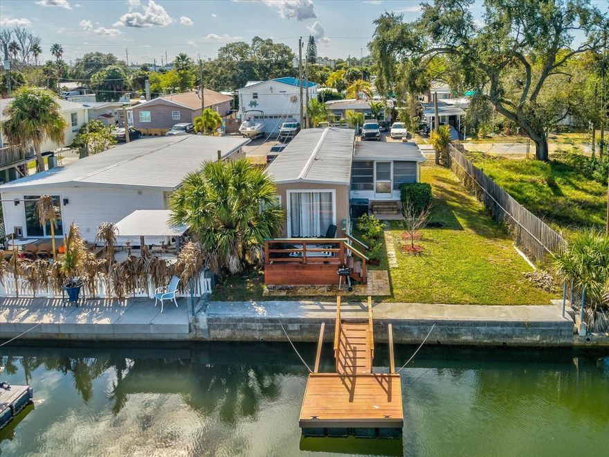 Welcome to your cozy coastal getaway on the water, where the weather is fantastic all year round. Unaffected by Hurricane Idalia!
This home is being sold turnkey and has been beautifully updated. There are ceramic tile flooring throughout and beautiful granite
countertops in the kitchen. Just bring your personal items! Walking in you will notice the light and bright features of the open floorplan. There is a wood deck in the back to enjoy the morning sunrise with coffee and/or evening sunsets, as well as the beautiful fruit trees. There is even an enclosed porch on the side for additional entertaining space to keep you out of the sun or rain. With direct Gulf access, you can bring your boat, kayak, paddleboard, etc. and truly live "the saltlife" Access to the Gulf is easy navigation from your floating dock to the open Gulf. This could be used as a vacation home, income producing property, or as your primary residence. The neighborhood is a golf cart neighborhood, so when your not enjoying the water, you can go for a ride to one of the local restaurants, ice cream shop, or Hudson Beach all without leaving the neighborhood.