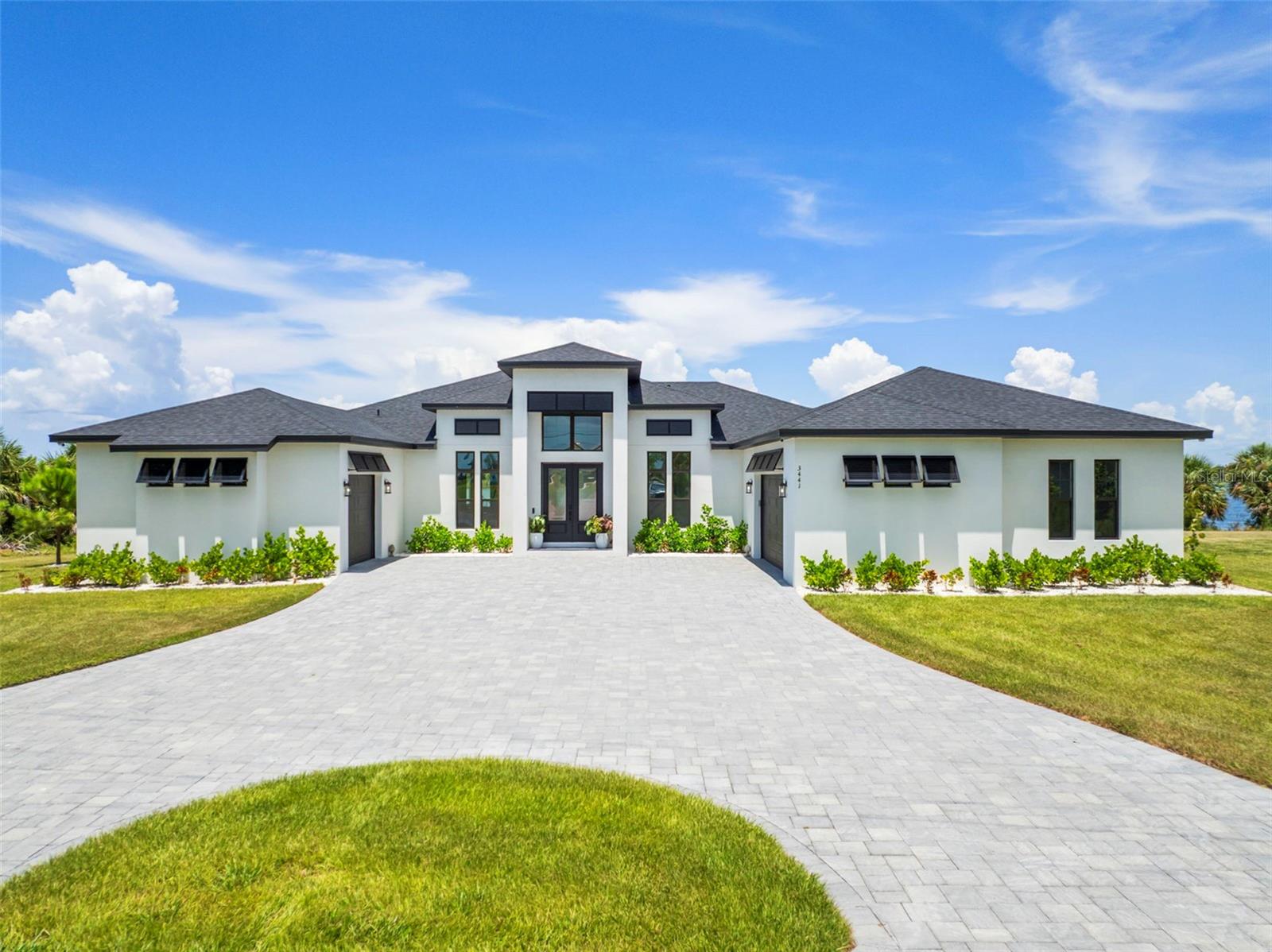 Welcome to your private waterfront oasis—an architectural masterpiece that blends modern elegance with serene, resort-style living. This custom-built 3-bedroom, 3-bathroom estate showcases beautiful design, luxurious finishes, and panoramic views of the water from nearly every room.
As you arrive, the grand circular driveway and striking contemporary facade set the tone for what lies beyond. Step inside to soaring ceilings, wide-plank wood floors, and a spacious open-concept living area centered around a stunning stone fireplace and built-in entertainment center.
The gourmet kitchen is a chef’s dream, complete with an oversized island, custom cabinetry, high-end appliances, and designer lighting. The owner's suite is a tranquil retreat with lakefront views, a spa-inspired bathroom, and private access to the covered lanai.
Outdoor living is elevated with a spectacular resort-style pool featuring fountains, integrated lighting, and a peaceful backdrop of the open lake. The expansive lanai is perfect for entertaining or relaxing with loved ones, offering plenty of room for both dining and lounging.
Set on an oversized lot with unobstructed water views, this home offers the perfect blend of privacy, elegance, and Florida luxury. Don’t miss the rare opportunity to own a waterfront residence of this caliber.