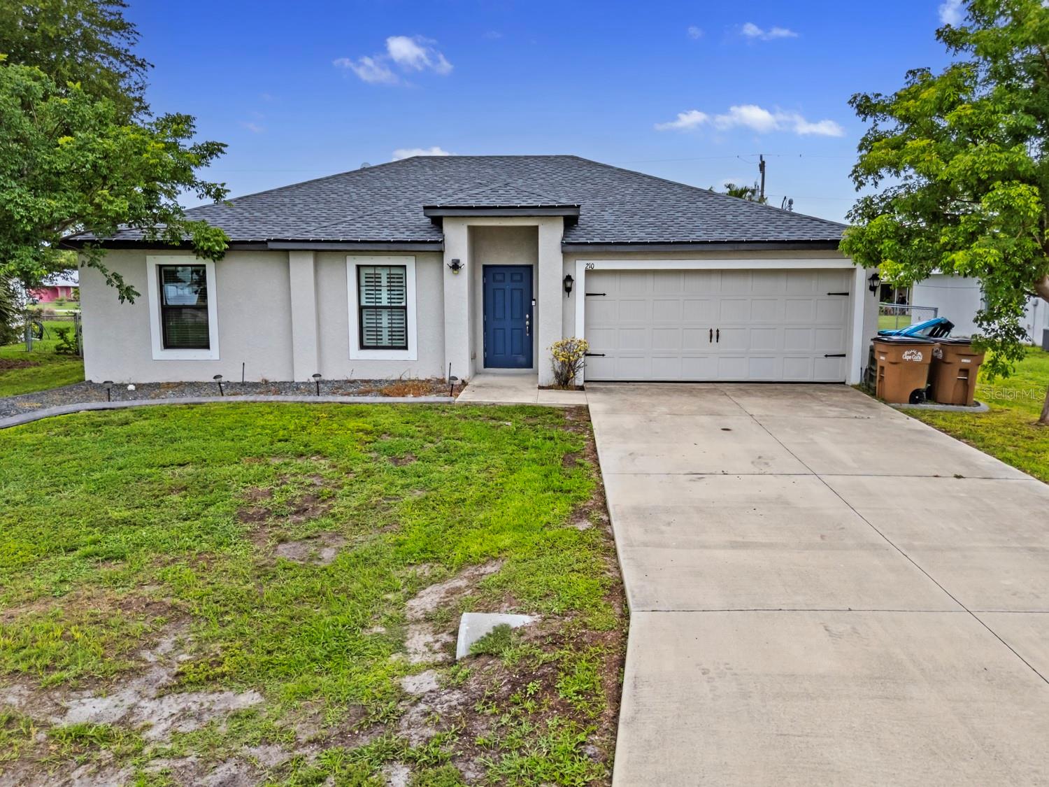 Welcome to 210 NE 24th Ave, Cape Coral! This beautifully maintained Vero floor plan offers 3 bedrooms, 2 bathrooms, and approximately 1,270 sq ft of living space—all on an oversized double lot. Enjoy a 2-car garage, new roof (2024), and the freedom of no HOA or CDD fees. The open one-story layout is perfect for relaxing or entertaining - outdoors you'll have an attachment for sun shade and plenty of space to expand or add a pool. Located in a desirable area close to shopping, dining, schools, and parks. Don’t miss this opportunity to make this home yours!