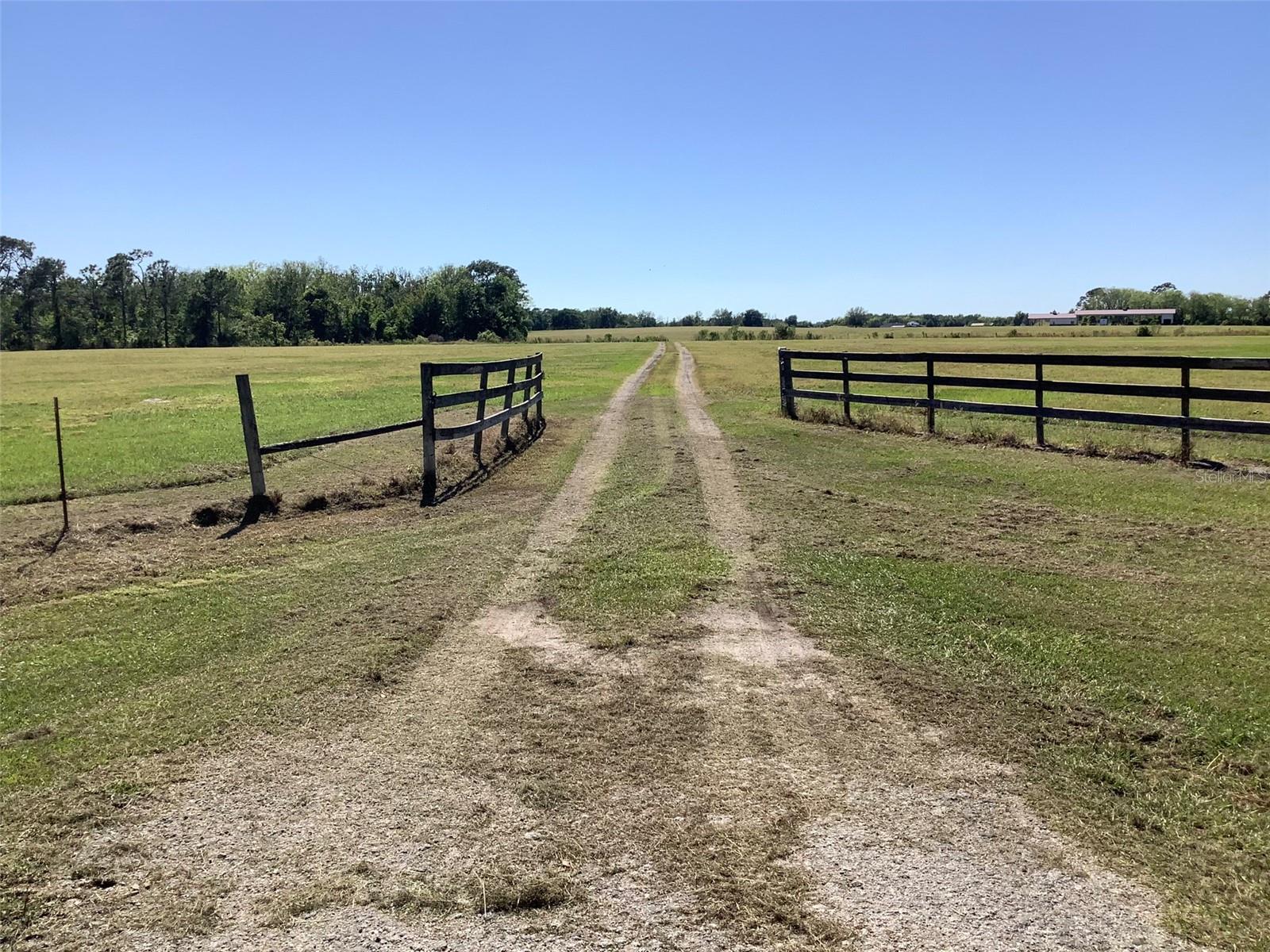 59 Acres of land currently zoned for Agriculture, In the past used for Growing Citrus Trees, Watermelons and Hay production. Plenty of pasture land and space for Cattle. Possibly be rezoned for development in the future. In an area with beautifully built new homes within less than a mile away. Also located on the property is a 162x30 Morton built office building which contains space for three offices and a Conference room, plus two bathrooms and snack and mini fridge area, Central heat and air. Covered parking and storage areas to park vehicles and Farm equipment and enclosed storage shed for supplies which includes sink area, air pump and refrigerator. Also private well and septic and plenty of space to add onto existing structures.
