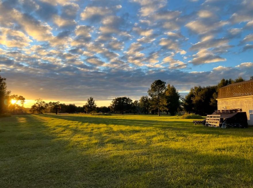 Discover the perfect blend of privacy, functionality, and opportunity on this beautiful 10+ acre agricultural-exempt property (USDA eligible), ideal for a family estate or two family residences. The land is already equipped with key infrastructure, including a well, two septic systems, and established electrical connections, offering a rare head start for your dream build(s). A finished workshop is already in place, along with one existing mobile home and a former mobile home site, providing flexible options for interim living, guest quarters, or future homesites.

The property features approximately 4 acres of open pasture, perfectly suited for livestock and is conveniently located next to a hay barn and a scenic 1.3 acres of wetlands complete with a fishing dock—an ideal spot to unwind and enjoy peaceful water views and sunset skies. Nearly 5 acres of pine grove provide natural beauty, shade, and added privacy, with fully fenced perimeter and a secure electric gated entrance.

With easy access to US-27 and the Florida Turnpike, this property offers a rare opportunity to enjoy the serenity of country living without sacrificing convenience. Whether you’re envisioning a private family compound, multi-generational living, or a working homestead, this property delivers space, infrastructure, and setting to bring your vision to life. (Previous/Historical sale price only includes 5 acres and 1 homesite, whereas the current listing reflects 10 acres and 2 homesites)