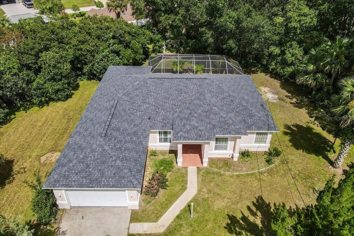 Spectacular concrete block pool home tucked at the end of a cul-de-sac—offering rare privacy with the option to purchase the lot next door for nearly a half acre of space! This four-bedroom, three-bathroom POOL home is packed with value and endless possibilities, priced under $400,000.
With a new roof in 2022 and 2012 AC, the major updates are already taken care of. Inside, soaring ceilings and a split floor plan fill the home with light and space. The updated primary suite is a retreat with dual closets, a spa-inspired bath featuring a walk-in tiled shower, garden tub, and dual vanities. Triple access points from the primary suite, formal living, and family room open directly to the pool—creating a true courtyard vibe perfect for entertaining. Every bedroom offers high ceilings, making this home feel even larger than its 2,352 sq ft.
Step out to your sparkling pool and expansive 25’ x 14’ covered patio to enjoy the ultimate Florida lifestyle. With no HOA fees, this property is perfect as a primary home, vacation retreat, or exciting Airbnb investment. The oversized two-car garage has space for cars, toys, and storage.
All this just 10 minutes to Flagler Beach, minutes from shopping and dining, close to Pine Lakes Golf Club, and surrounded by beautiful walking and bike paths. Privacy, location, lifestyle, and opportunity all rolled into one!