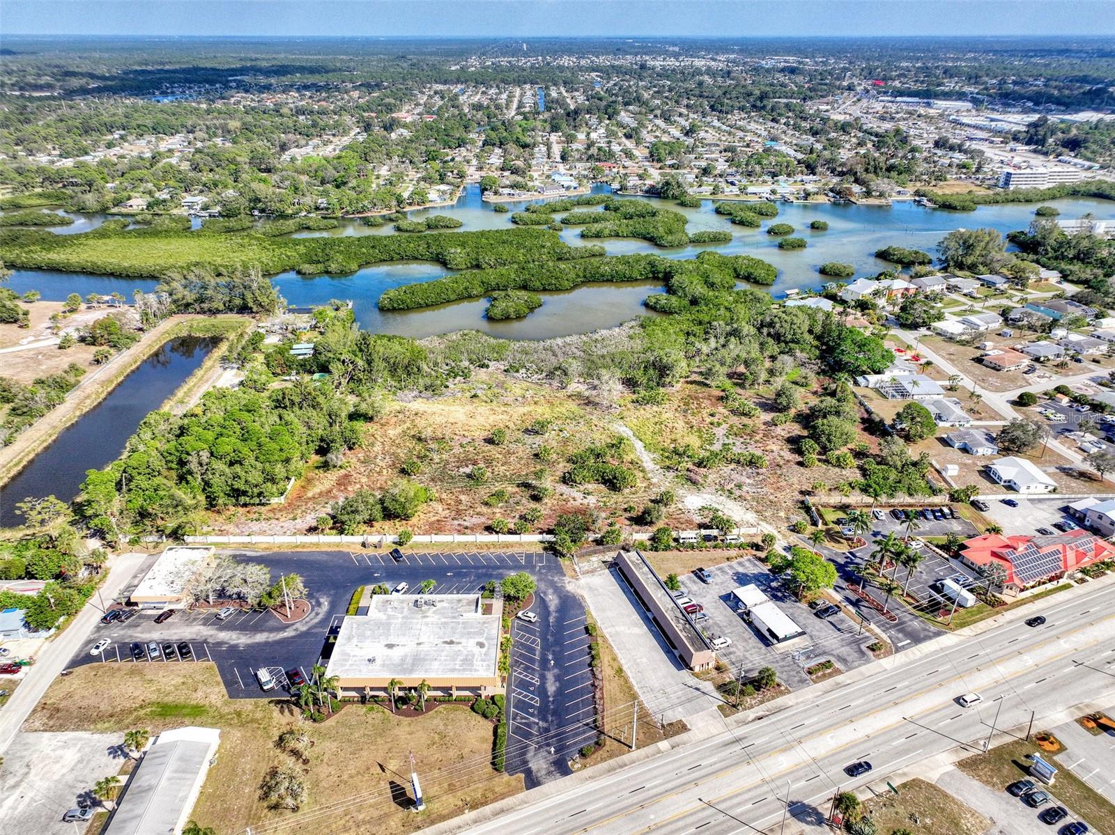Attention Developers, large water view parcel only a bike ride to Englewood Beach. 6.4 acres allows for 64 condo units. There is no other parcel like it in the area. 6.4 acres of larger parcel to be split prior to sale, seller will pay costs associated with splitting.