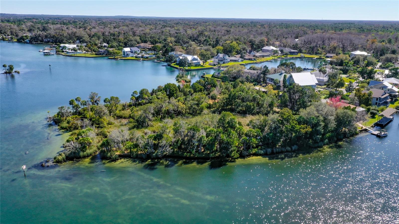 Once-in-a-Lifetime Waterfront Opportunity – 3-Acre Private Peninsula in Crystal River! What an incredible chance to own one of the most unique and breathtaking waterfront properties on Florida’s Nature Coast! This privately fenced 3-acre (MOL) peninsula offers approximately 2,000 linear feet of bulkhead shoreline with panoramic water views in every direction. Nestled at the edge of Kings Spring, this one-of-a-kind homesite provides unparalleled access to some of the clearest freshwater in the state—perfect for fishing, kayaking, or simply enjoying the daily visits from manatees and dolphins. This property comes with a valid Army Corps of Engineers permit and a DEP permit, allowing for the addition of .25 acres of fill dirt to build your dream home. Both permits are transferable and active until 2027, with options for extension. City water and sewer are already hooked up and paid for, saving you thousands in upfront utility costs. Imagine relaxing in a custom home surrounded by Bottle Brush trees, natural springs, and open water views on three sides. Enjoy peaceful privacy while being just minutes from downtown Crystal River's shops, restaurants, and festivals. Walk, golf cart, or paddle to nearby attractions including Three Sisters Springs. Call today to schedule your private tour of this remarkable waterfront sanctuary. Opportunities like this don’t come often—secure your piece of paradise!