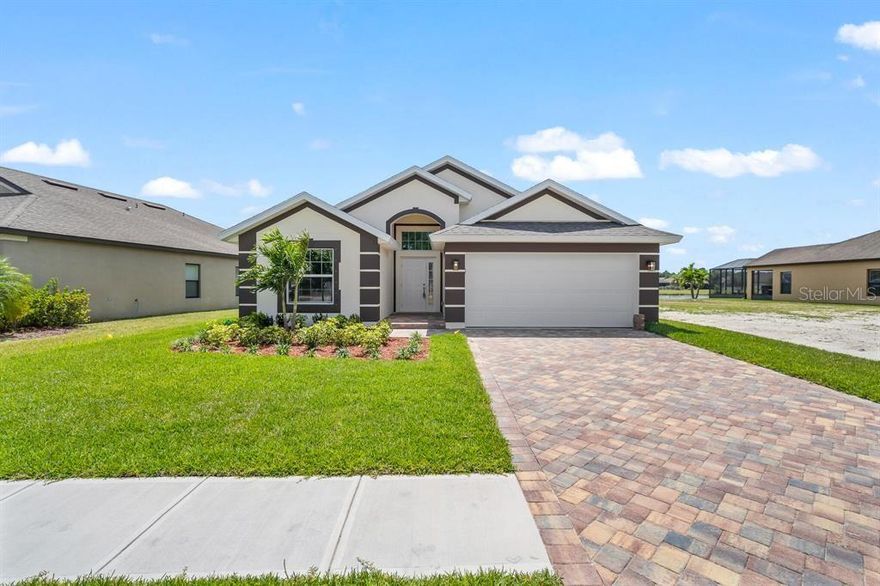 4-bedroom, 2-bathroom new construction home with a lake view in the Amberwood at Bayside Lakes community in Palm Bay, FL
