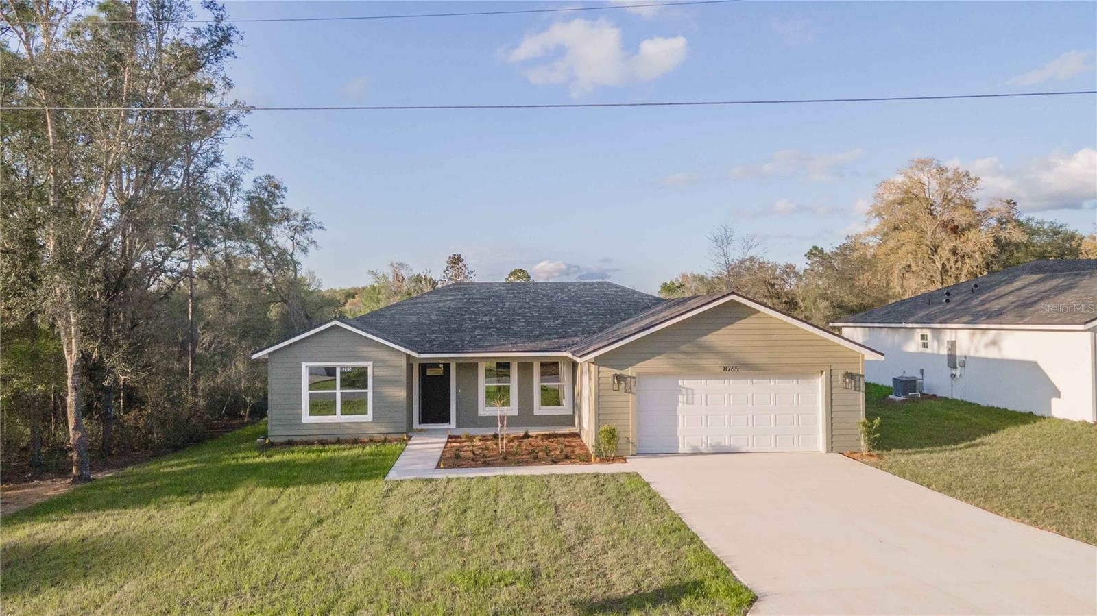 HOME AVAILABLE!! Located in the family-friendly neighborhood of Orange Blossom Hills, this 3BR/2BA is within arm's length of THE VILLAGES, Mulberry Grove Plaza, Ocala, shopping, dining, schools, and much more. Situated on an OVERSIZED .22 acre lot this home offers plenty of space to stretch out arms without feeling stacked. Comprising a total of 1,530+/- sqft under air this home features a split floor plan with high ceilings, vinyl plank, an inside laundry room, a 2-car garage, a covered patio, and a mud room. The kitchen features quartz countertops, stainless steel appliances, and soft-close cabinetry. The master bedroom is enhanced with a walk-in closet and an ensuite including his/hers sinks, and a seamless walk-in shower. The spare bedrooms are spacious with a shared hall bath and linen closet. With plenty of space for your family, you'll love everything that this home has to offer with a great neighborhood. Move-in Costs are First month's rent ($2,100) and Security Deposit ($2,100). Tenant application approval is required. No Smoking.