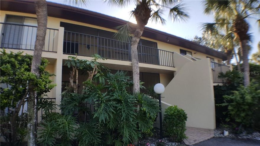 This delightful second-floor condo is located in the serene community of Wild Oak Bay, nestled along the shores of Sarasota Bay. Enjoy the beauty of the bay area and its abundant natural surroundings. Access to this condo is via stairs leading to the second floor, providing privacy and a sense of elevation. The spacious living and dining area creates a welcoming environment with room for relaxation and entertainment. The kitchen is equipped with granite countertops and comes complete with all essential appliances, including a washer and dryer. Cooking and meal prep will be a breeze. The master bedroom features a luxurious king-sized bed and an ensuite bathroom with a shower. The guest bedroom includes a queen-sized bed and an adjacent bathroom with a tub/shower combination. Enjoy your morning coffee in the glassed-in patio, which overlooks a tranquil pond and the community's heated pool. A covered/open balcony provides additional outdoor space to unwind and there are stairs that take you down for easier access to the yard and lake. The property is surrounded by mature landscaping, creating a peaceful and natural atmosphere. It's a perfect escape from the hustle and bustle of daily life. Residents have access to a heated pool and hot tub, ideal for relaxation and leisure. Take a dip or unwind after a long day. This condo is conveniently located near the IMG Sports Academy and the State College of Florida, making it an ideal residence for all. Enjoy easy access to Bradenton and Sarasota's stunning beaches, where you can soak up the sun, swim in the turquoise waters, and savor the coastal lifestyle. This splendid condo is available for lease. Act quickly to secure this fantastic home.
