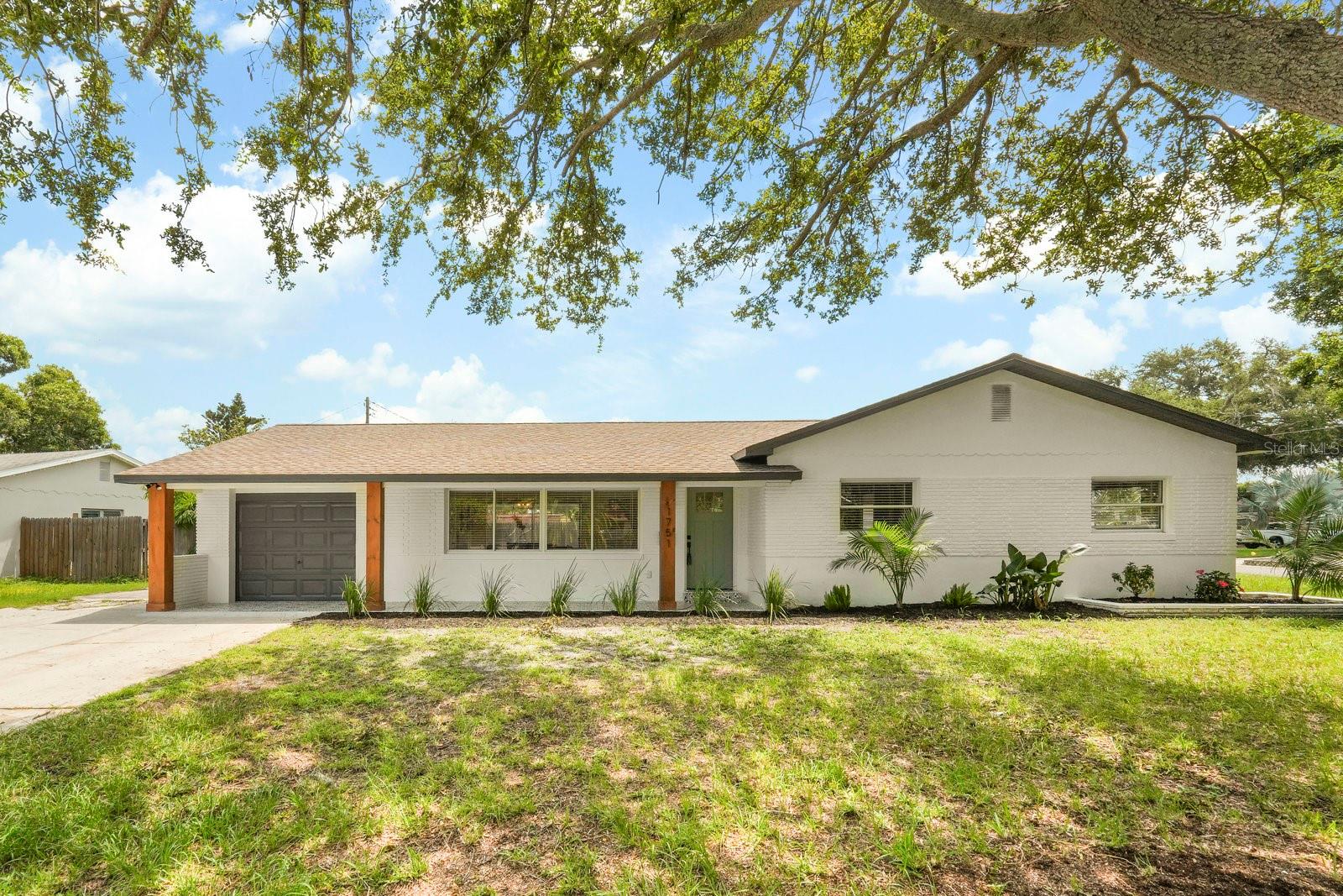 Welcome to your private SANCTUARY! This 3 Bedroom- 2 Bath with one car garage gem is situated on a corner lot in the heart of vibrant St. Petersburg. This beautifully updated home blends contemporary style with everyday comfort, offering a thoughtfully designed layout and premium upgrades throughout. The kitchen has been remodeled to perfection with sleek modern cabinetry, quartz countertops, and stainless-steel appliances—an ideal space for both seasoned chefs and culinary enthusiasts. The primary suite offers a relaxing retreat, complete with an en-suite bathroom featuring a brand-new walk-in shower. Luxury vinyl flooring flows seamlessly through the open concept living areas, enhancing the warmth and elegance of the home. Both bathrooms have been tastefully updated with modern finishes, and the spacious screened-in patio provides a serene outdoor escape. The oversized one-car garage and generous driveway offer ample parking and storage options. Located just minutes from sun-soaked beaches and the dynamic downtown area, you’ll enjoy easy access to shopping, dining, and cultural experiences. This home offers the perfect balance of tranquility and excitement. More than just a residence, it’s a lifestyle. Schedule your private showing today and take the first step toward living your dream in sunny St. Petersburg!