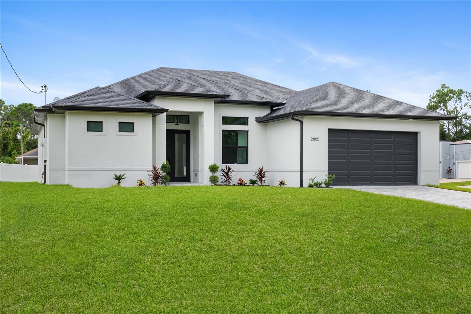 MOVE-IN-READY, NEW CONSTRUCTION" Corner Lot with 3 bedroom, 2 bathroom ( office!) You're going to love all of the high-end finishes that were chosen with luxury in mind. From paver driveway to ALL IMPACT doors and windows. As you enter the home you're immediately greeted by High Ceilings and a large triple Impact Slider that draws your attention to the oversized lanai featuring a large backyard. You'll love the oversized 10ft island in your beautiful kitchen with upgraded stainless-steel appliances and a pantry for all your culinary needs. Your main bedroom features high ceilings and walk-in closet with a master bath featuring double showers with glass and two modern vanities. Of course, we have to mention the upgrades that make this home unique: upgraded appliances package, expanded hall ways, trey ceilings, plumbing for outdoor kitchen, recessed A/C unit in garage, extended garage to fit any size car / truck, glass doors in den, Nest thermostat are just a few of the luxurious features and the list goes on and on.