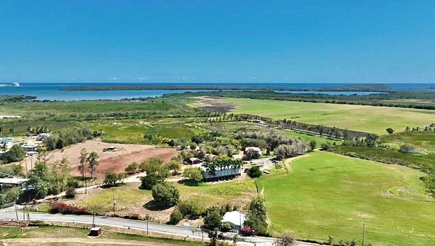 Rarely does a property define an entire region, but this 613-acre coastal empire in Guayanilla is the definitive exception. Stepping onto this land feels like walking through a living timeline, where the stone ruins of an 1880 sugar cane mill stand as a testament to a century-old legacy, now ready for a modern revival as a world-class distillery or event venue. This is a high-functioning powerhouse, sold as a true "turn-key" operation with over $1 million in premium, recently purchased tractors and farm equipment included to maintain the highly productive hay fields. The infrastructure is massive and meticulous: a sprawling main residence, a specialized drive-thru hay barn designed for maximum efficiency, a dedicated equipment barn, and professional-grade horse stalls. With natural springs, fresh water canals, and direct river and bayfront access, the scale for eco-tourism or agricultural expansion is unmatched in Puerto Rico. From the active water extraction permits to the vast coastal acreage, this isn't just a land purchase—it’s the acquisition of a ready-made legacy.