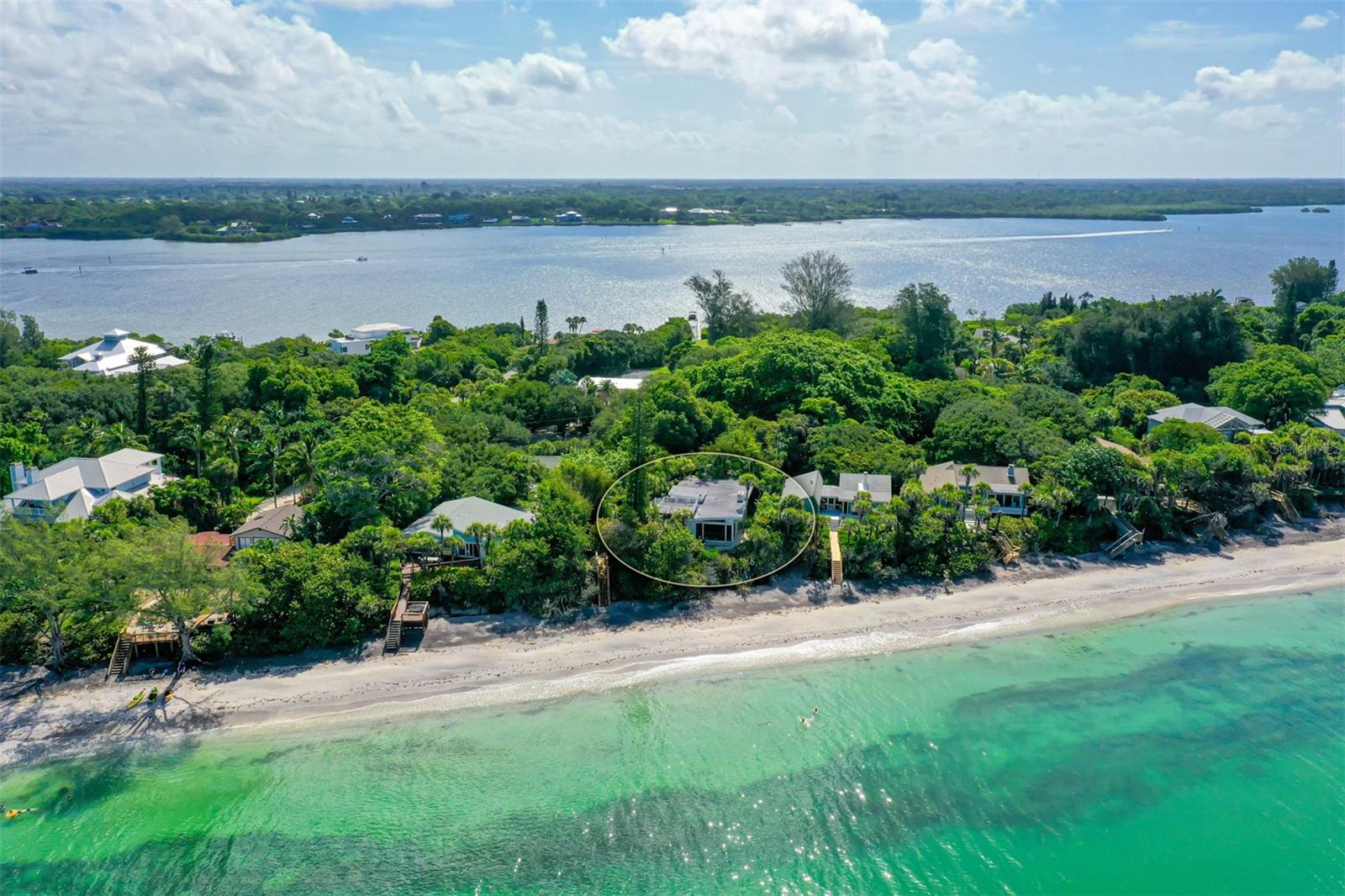 Amazing Sunsets awaits you at this very private tropical paradise. Lush landscaping and oak trees invite you into this Beach Cottage, Great room with high ceilings and wood burning fireplace, kitchen with Gulf views to enjoy cooking and entertaining. The two Guest Bedrooms are on the lower level with private bath and separate entrance. Casual and inviting this home captures the beach experience. The Guest House at 7565 Manasota Key is included, features 3 bedrooms, 2 baths totally renovated with private dock on Lemon Bay.