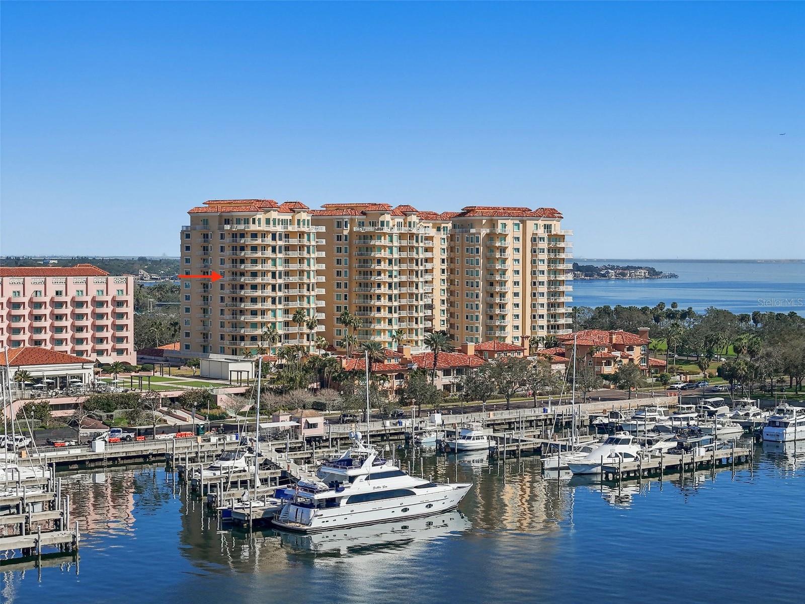 Experience unparalleled luxury at Vinoy Place, one of downtown St. Petersburg’s most prestigious WATERFRONT residences. This 3,300 square-foot condominium offers an exquisite blend of sophistication, modern design, and breathtaking views, overlooking the downtown waterfront, iconic St. Pete Pier, and vibrant city skyline. With three bedrooms, two and a half bathrooms, and expansive wrap-around balconies, this home is designed for those who seek both elegance and convenience.
Step off the private elevator into a beautifully designed foyer, featuring custom paint treatments that set the tone for the refined interiors. The open-concept living area is framed by floor-to-ceiling windows, bathing the space in natural light while capturing the picturesque waterfront views. The 2019 remodeled kitchen is a chef’s dream, featuring built-in shelving, ample storage, and an eat-in breakfast area, perfect for casual dining or entertaining.
This residence has been meticulously upgraded, with newer HVAC systems, including the most recent 2023 installation for the 220 sq. ft. storage room, ensuring optimal climate control. Both the primary and guest bathrooms were updated in 2023, featuring high-end finishes and premium fixtures. The main living areas showcase stunning hardwood flooring, while the primary bedroom is fitted with plush new carpeting, creating a warm and inviting retreat. Additional upgrades include electric blinds and window treatments throughout the main living area, providing effortless light control.
Designed for functionality without compromising on luxury, the bedroom closets have been customized offering maximum storage and organization. One of the guest bedroom features a Murphy bed, making it ideal for visitors or use as a multi-purpose space. A built-in desk unit in the family room provides the perfect workspace for a home office or study area.
This unit has superb covered parking spaces, with one being just feet away from the elevator and the other a short additional distance. This unit features the normal storage unit all other units have plus the previously noted large, air conditioned storage unit of approximately 220 square feet.
Residents of Vinoy Place enjoy a wealth of exclusive amenities, including 24-hour gated security, secured covered parking, private storage rooms, a state-of-the-art fitness center, reservable meeting rooms, and two resort-style pools with spas. Additionally, membership to the neighboring Vinoy Club provides access to tennis courts, a championship golf course, and a private restaurant, elevating the lifestyle experience even further.
Nestled in the heart of downtown St. Petersburg, this extraordinary residence is just steps from fine dining, boutique shopping, waterfront parks, and cultural attractions. Whether as a primary residence or a seasonal retreat, this Vinoy Place condominium offers the ultimate in luxury, privacy, and panoramic waterfront living.