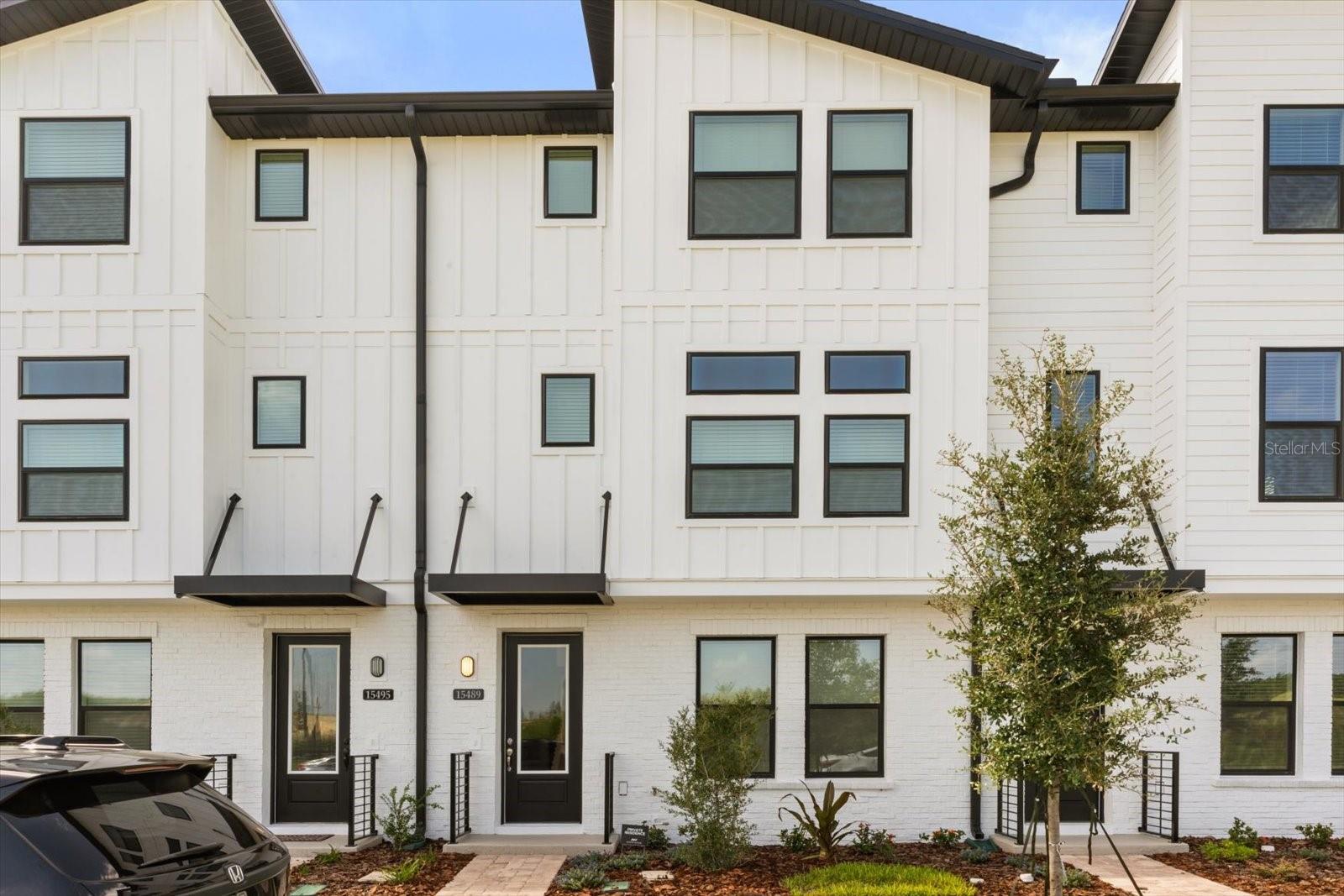 Be the First to Live in This Brand-New, Luxury Townhome in Parkview at Hamlin! This Haines II, stunning 3-bedroom, 2.5-bathroom, 3-story townhome in the highly desirable Parkview at Hamlin community of Winter Garden was just completed and never lived in. Inside, you’ll find a thoughtfully designed floor plan with three private suites, including a first-floor guest suite and a luxurious third-floor primary retreat with a frameless glass shower. The second floor is ideal for entertaining with an open-concept living room and a gourmet kitchen featuring 42” gray cabinets, stainless steel GE appliances, white quartz countertops, and durable vinyl plank flooring. Step outside to the covered lanai for morning coffee or unwind in style with low-maintenance living at its best. This home boasts a high-efficiency, high-tech air conditioning system for year-round comfort and energy savings. Located in a walkable, vibrant community with access to dining, shopping and entertainment, this townhome is perfect for those who want modern luxury with everyday convenience. Don’t miss the chance to be the very first resident of this brand-new home—schedule your showing today!
